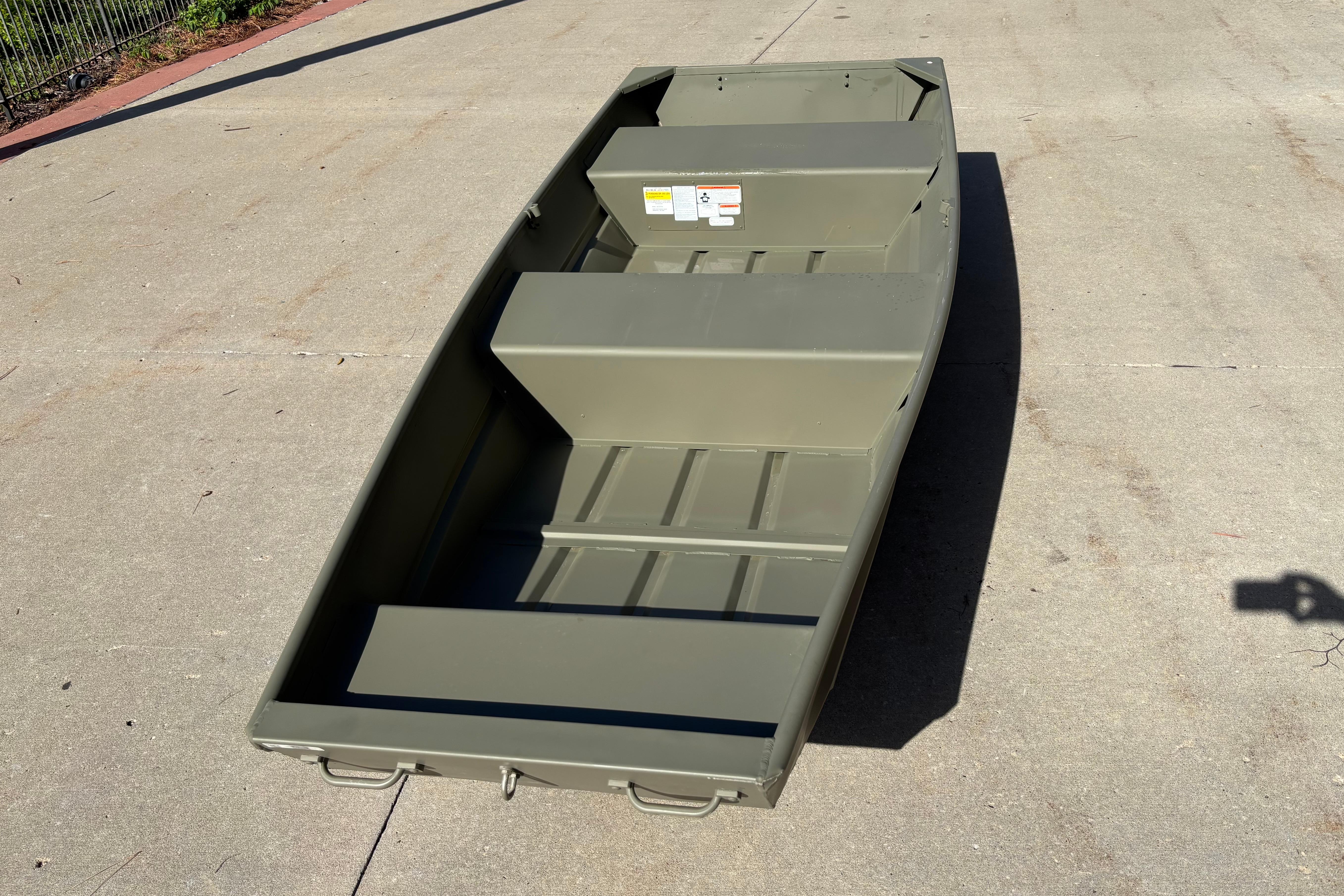 2026 Tracker Grizzly 12 Jon boat on concrete surface, showcasing its sturdy design.