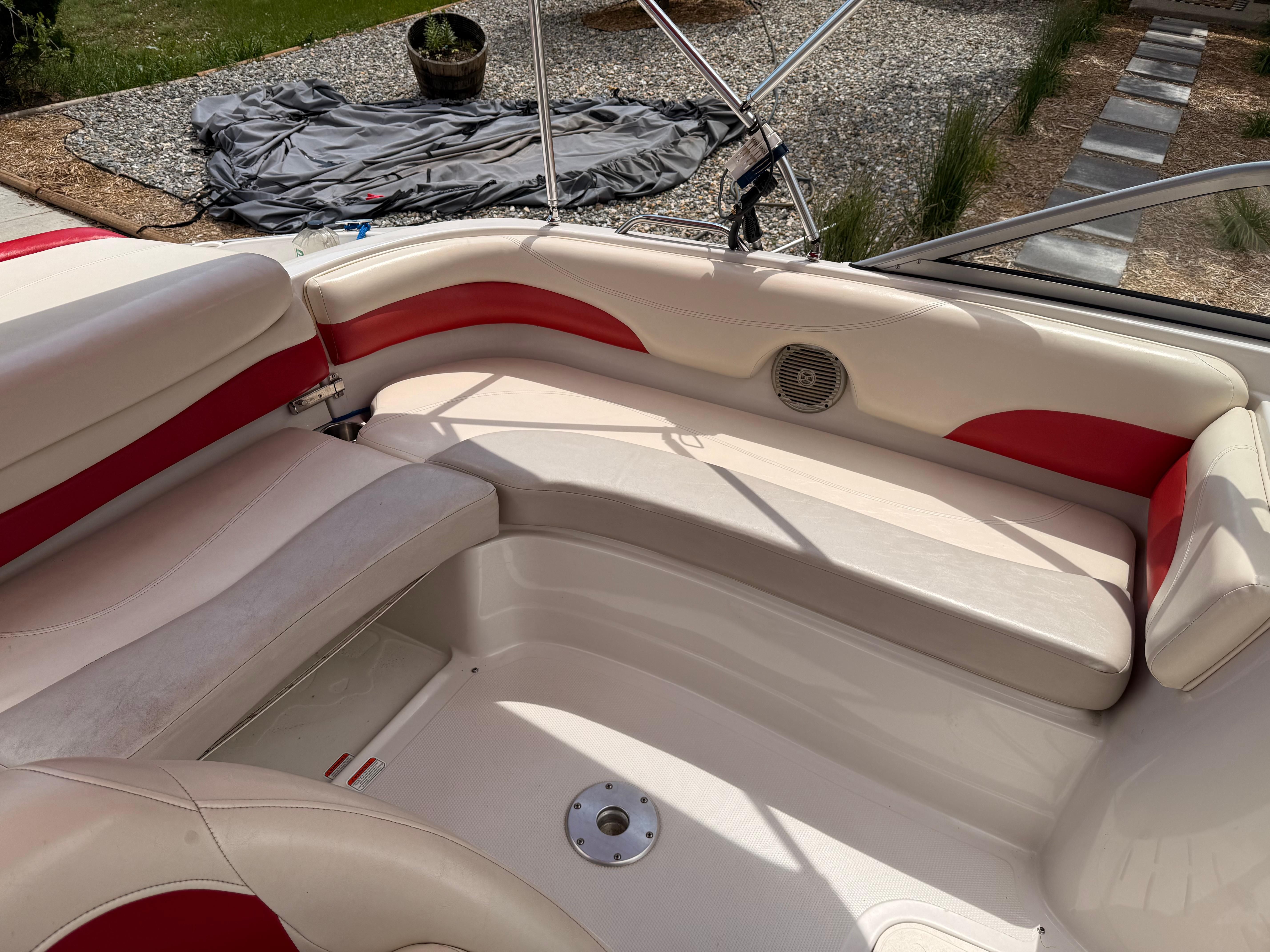Interior of a 2011 Tahoe 216 WT boat with red accents.
