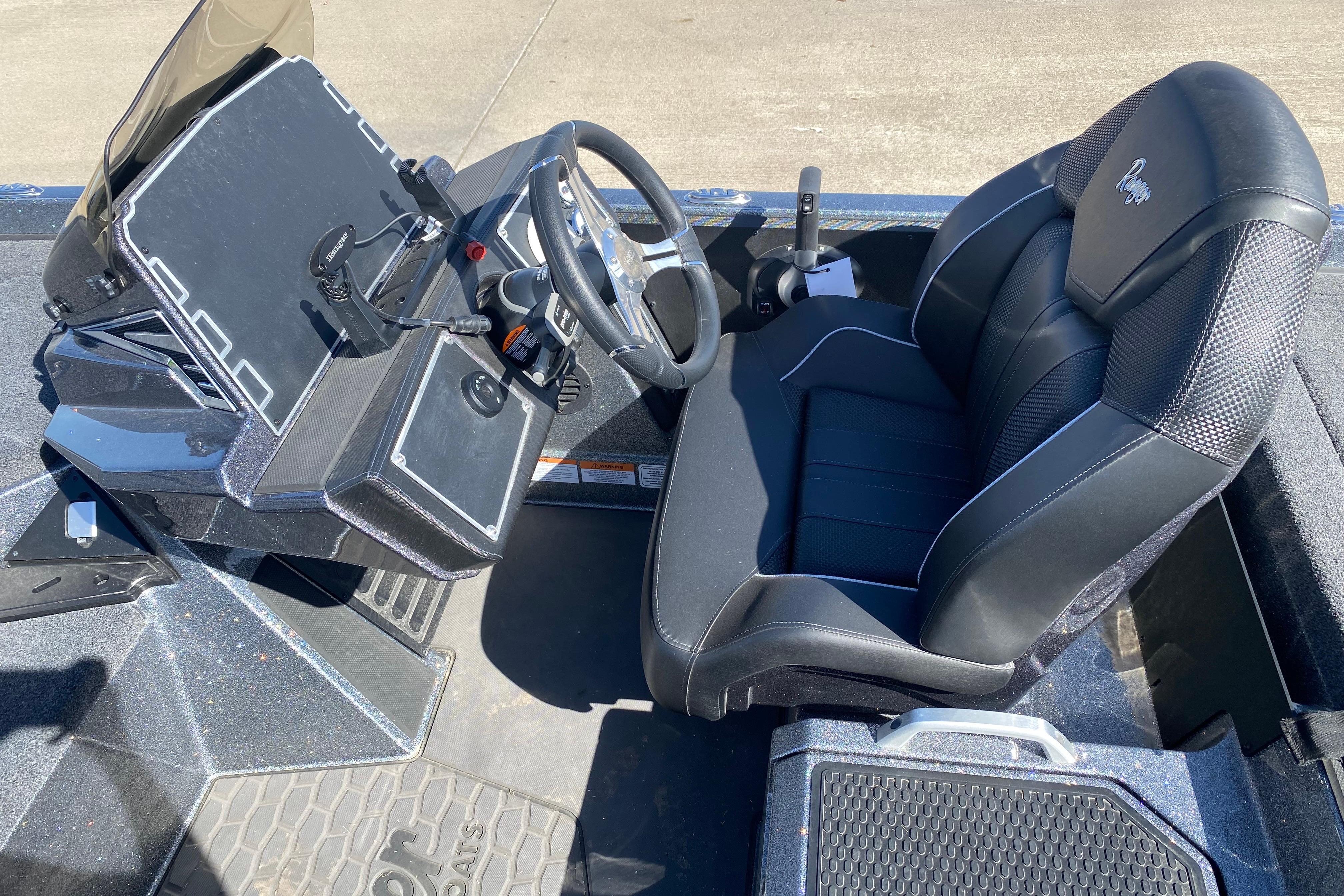 2025 Ranger Z520 boat cockpit with steering wheel and black seat.