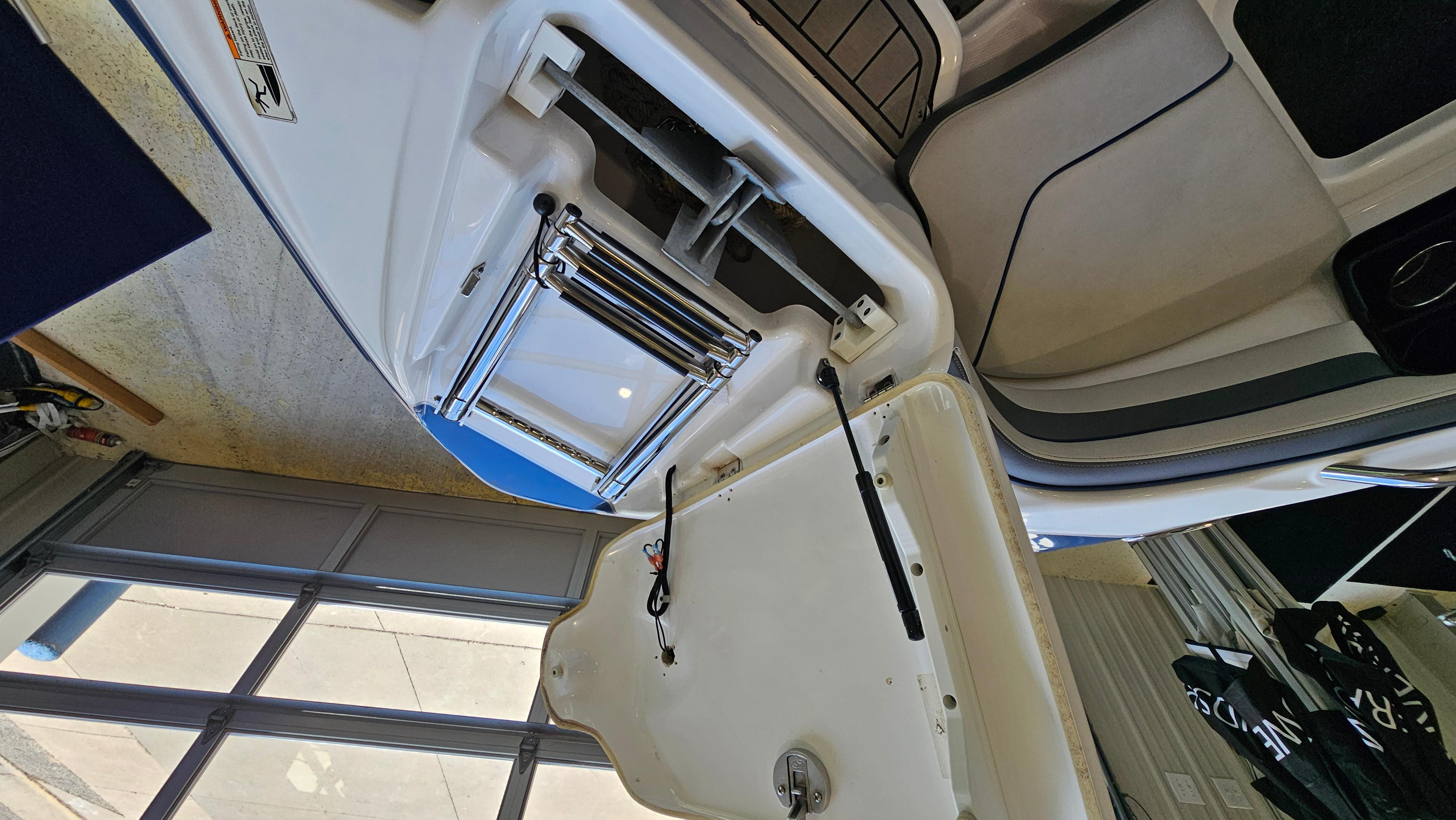 2020 Yamaha SX240 boat interior with open storage compartment and ladder.