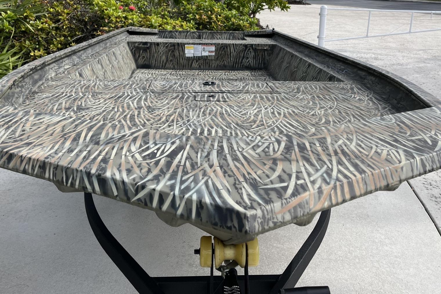 2025 Tracker Grizzly 1860 Utility boat with camouflage pattern on a trailer.