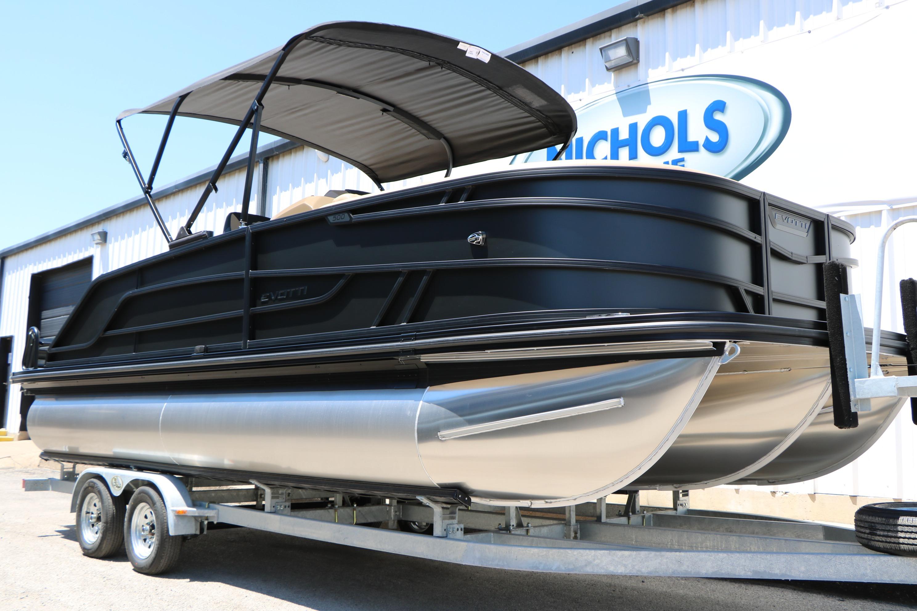 2026 Evotti 521CS pontoon boat on trailer, black exterior, parked outside dealership.