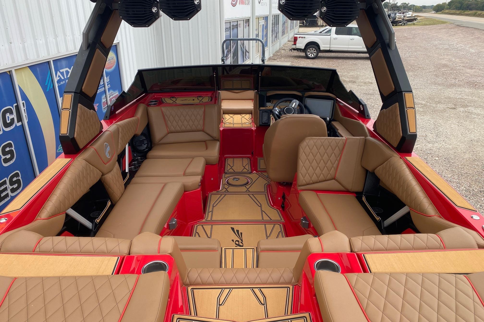 2026 Tigé Z3 boat interior with luxurious tan seating and red accents.