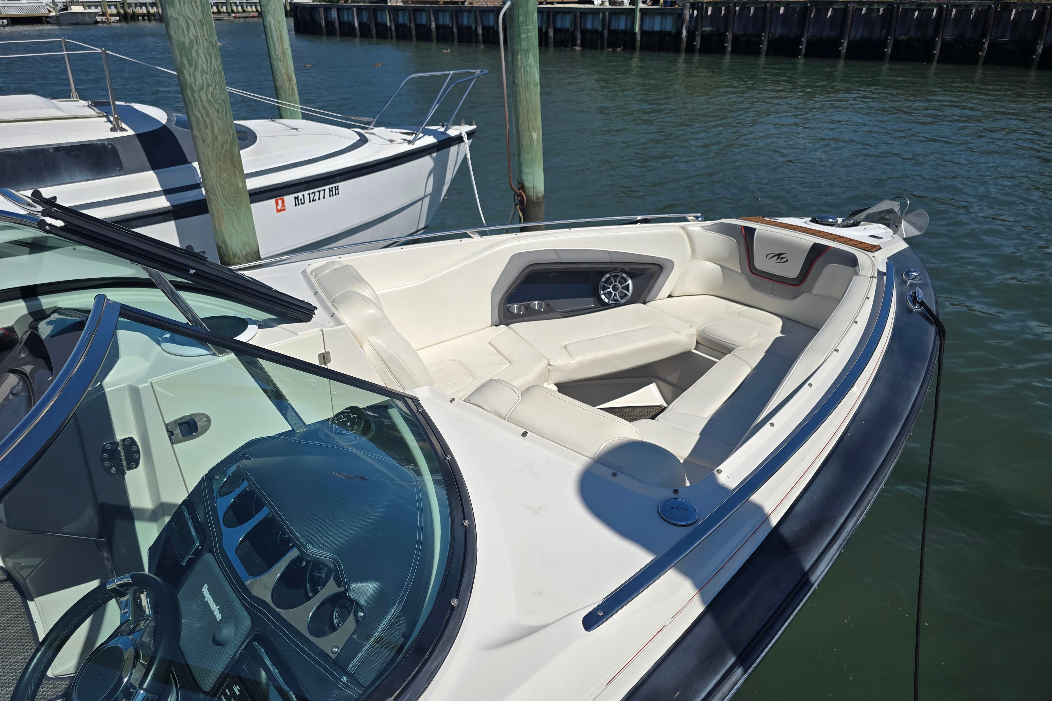 2014 Monterey 288 Super Sport boat docked, featuring spacious seating and sleek design.