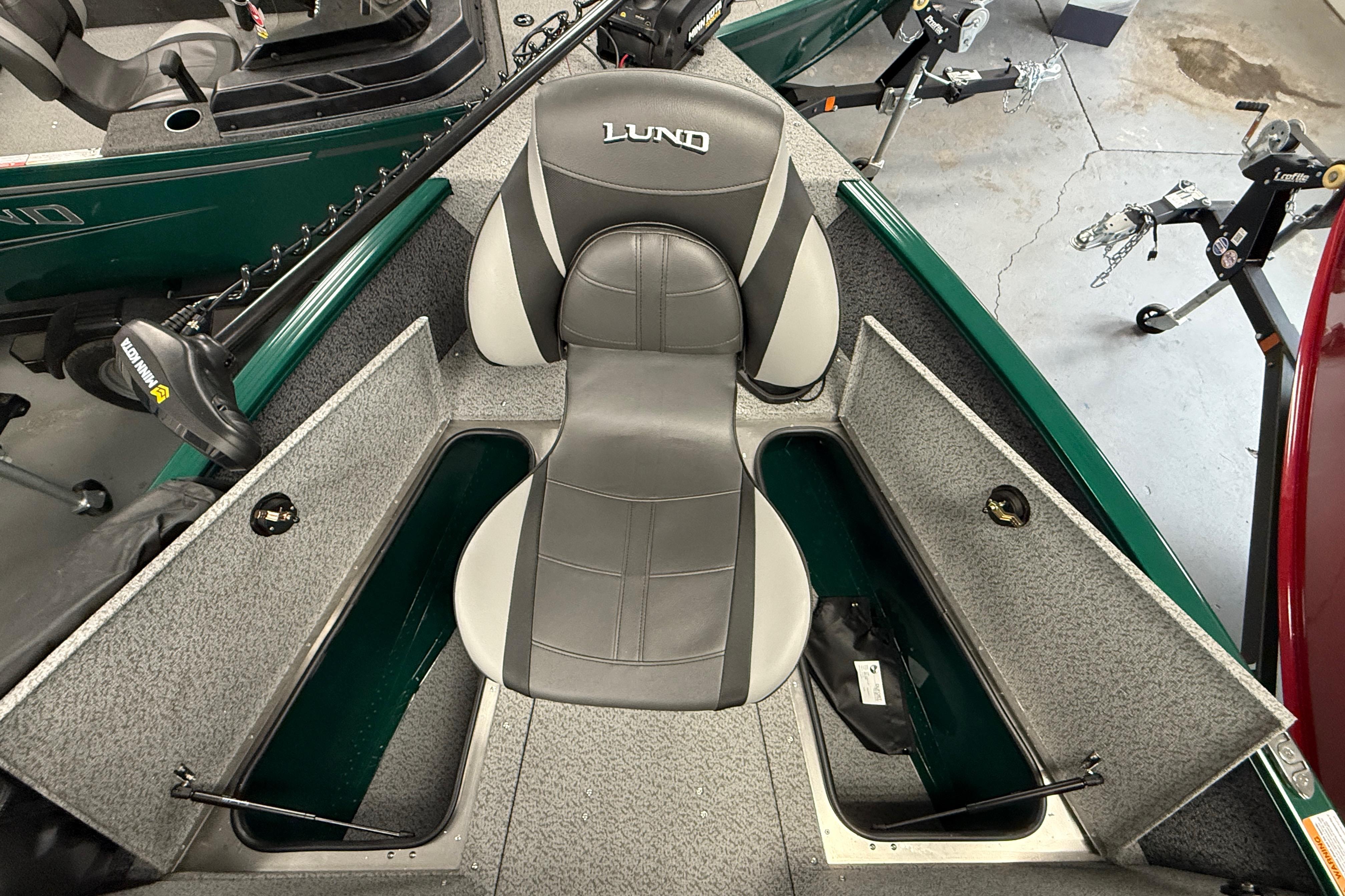 2026 Lund 1775 Adventure Sport boat interior with storage compartments and seating.