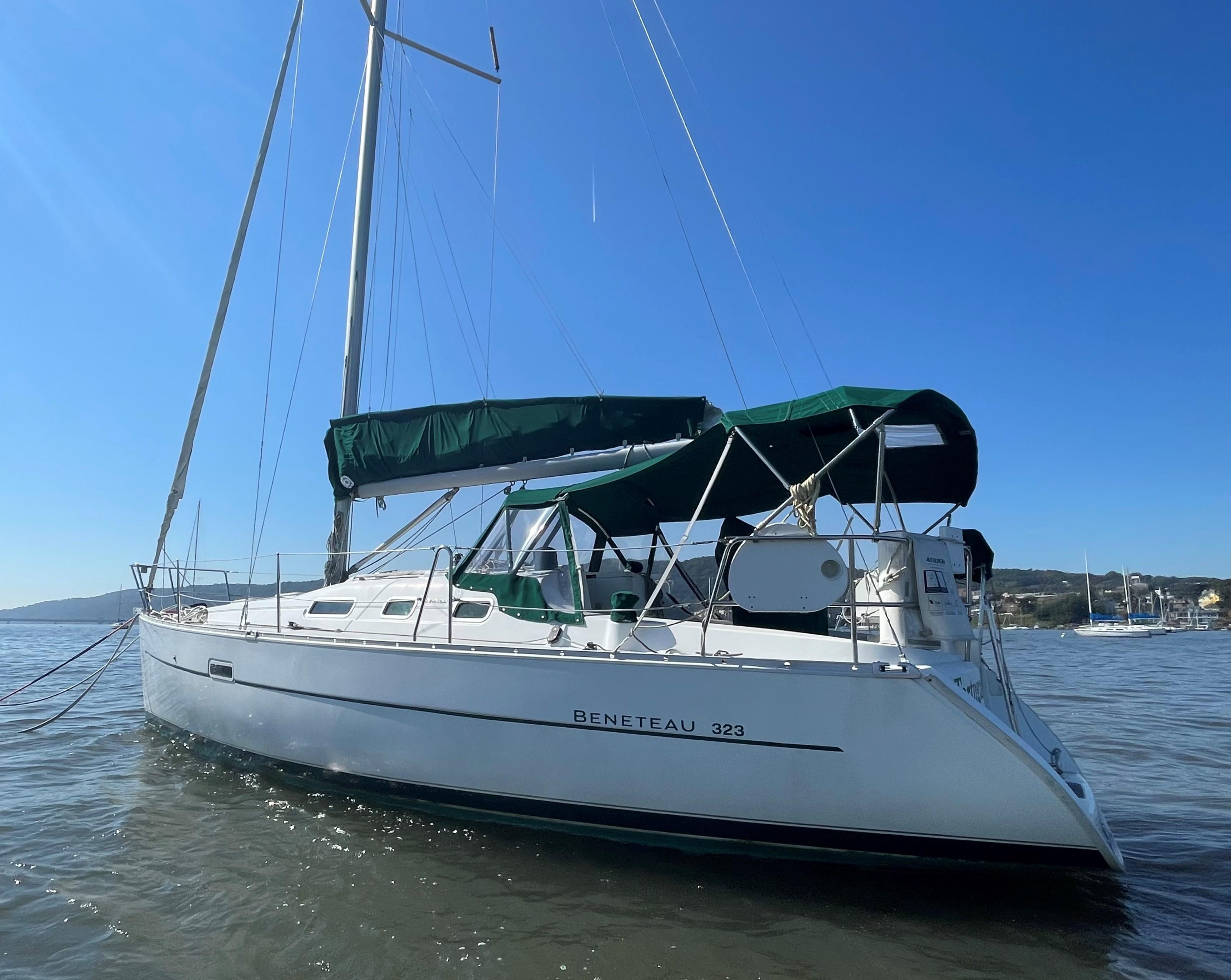 2005 Beneteau 323 sailboat on calm waters.
