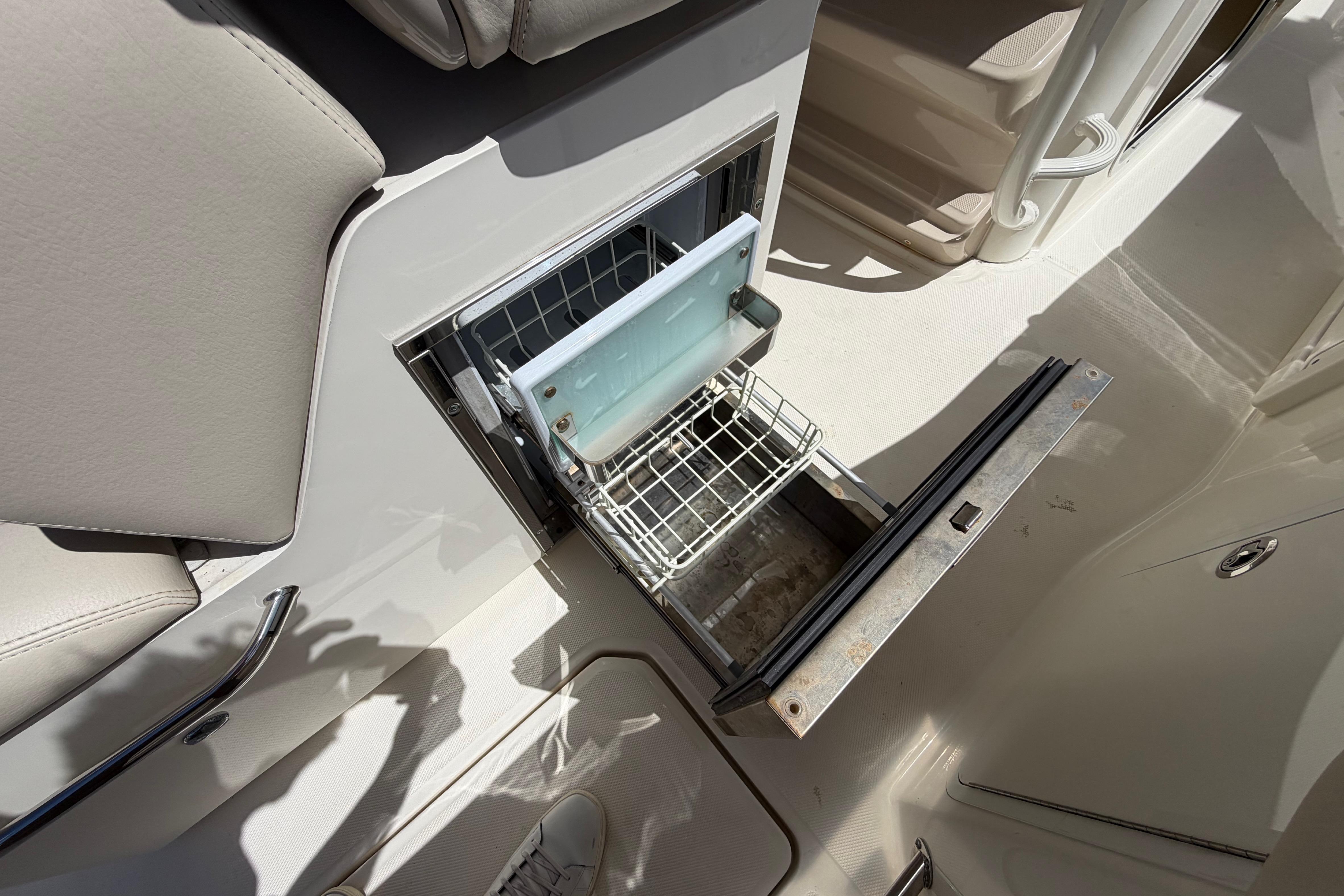 Open storage compartment on 2019 Boston Whaler 330 Outrage boat interior.