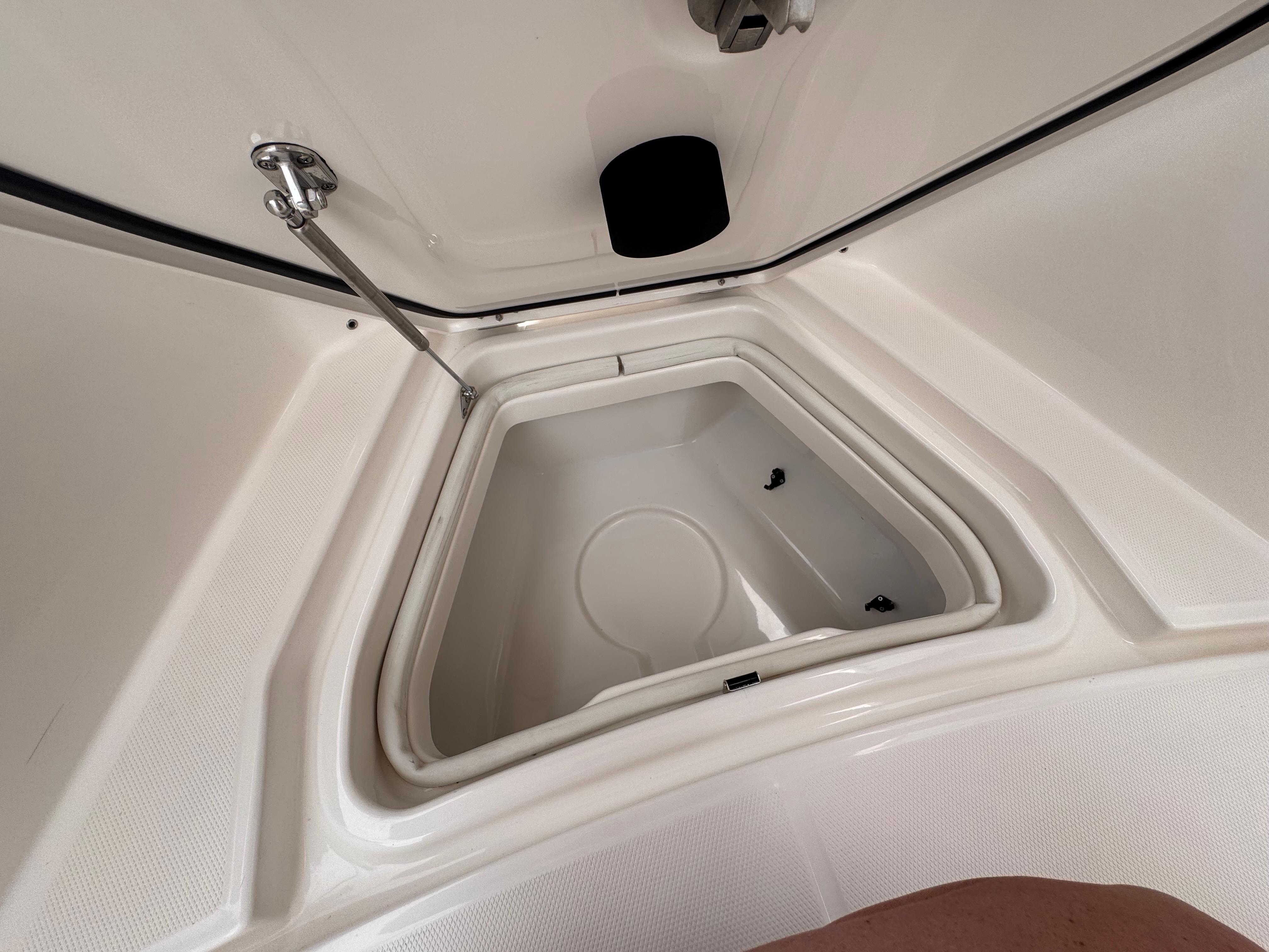 Interior storage compartment of 2025 Solace 30 CS boat, featuring a sleek, white design.