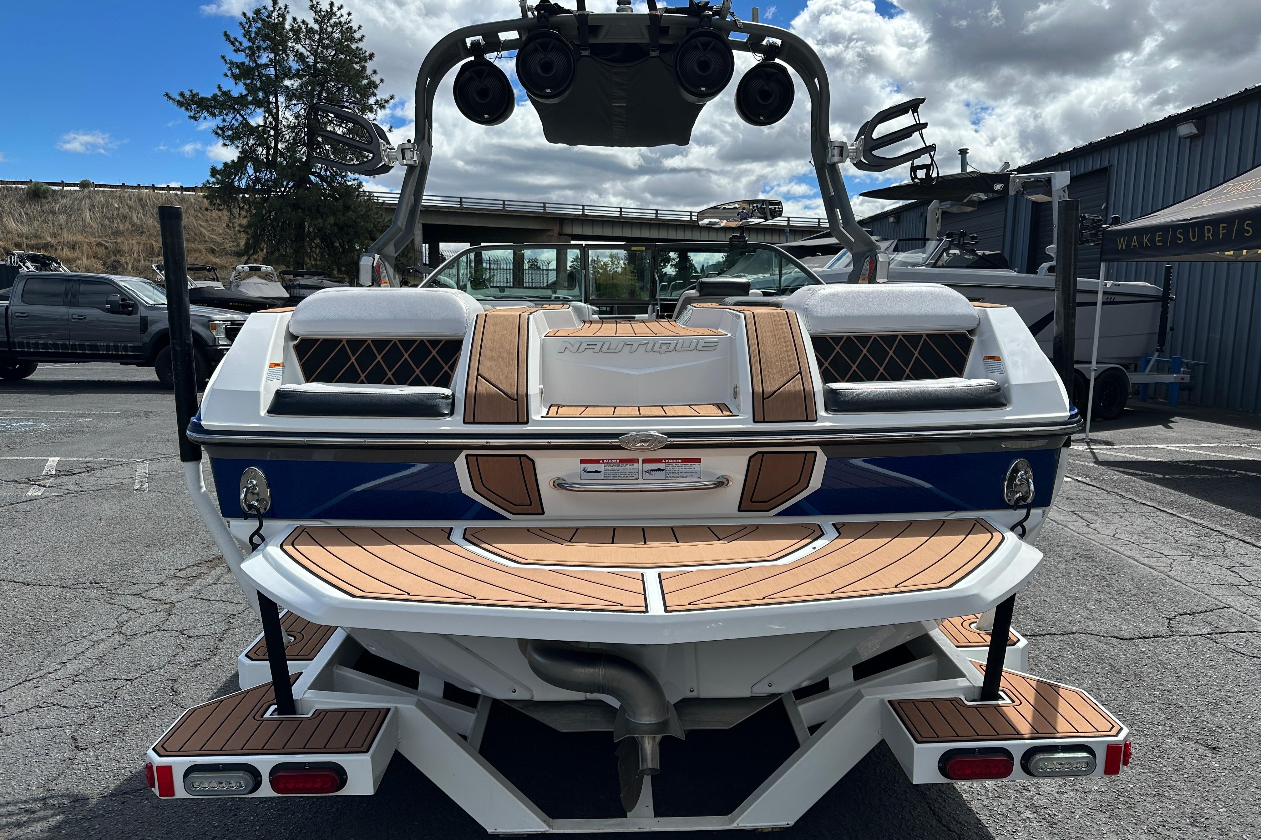 2017 Nautique Super Air Nautique GS20 boat, rear view, parked outdoors.