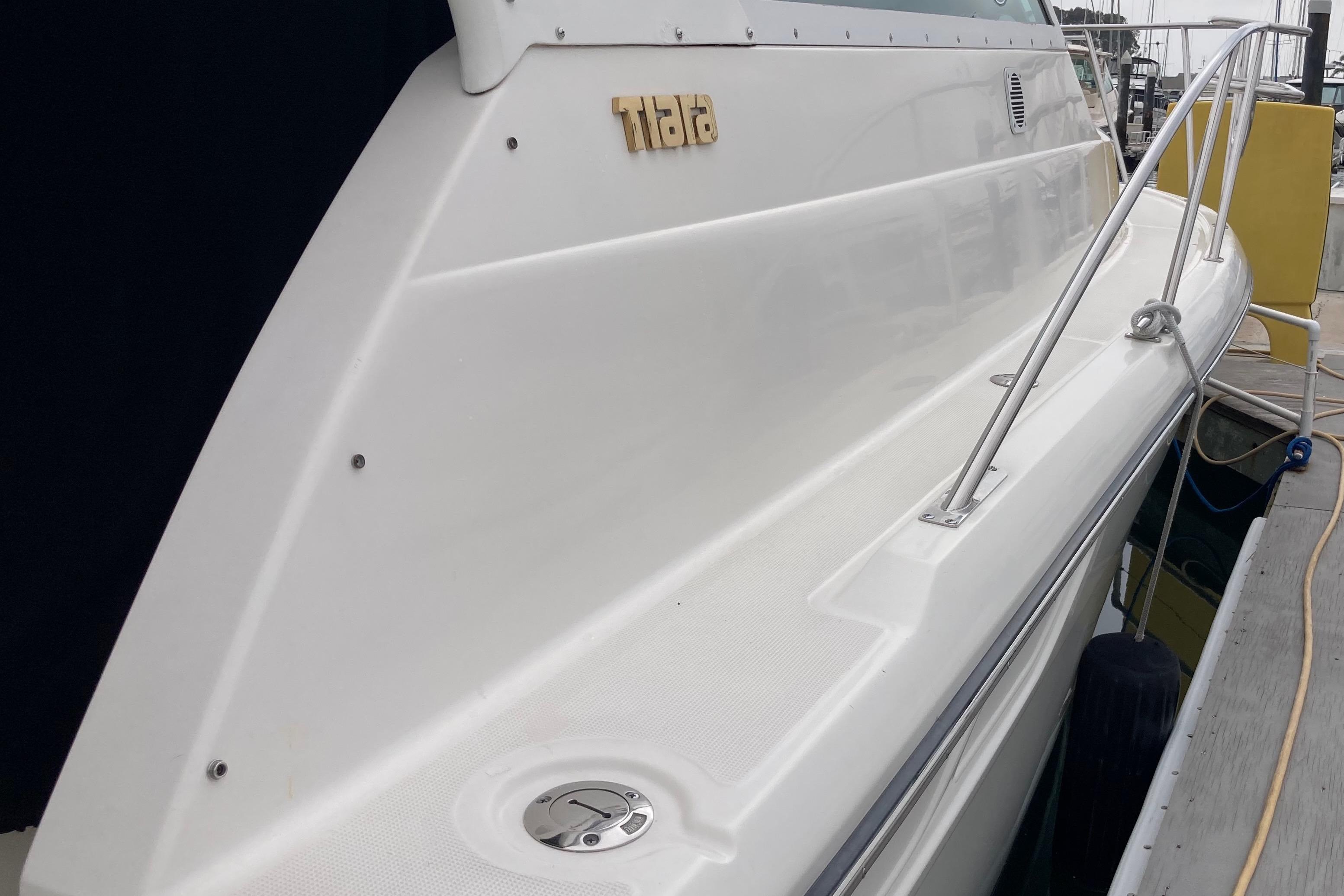 2002 Tiara Yachts 2900 Open docked, showcasing sleek white exterior and railing.