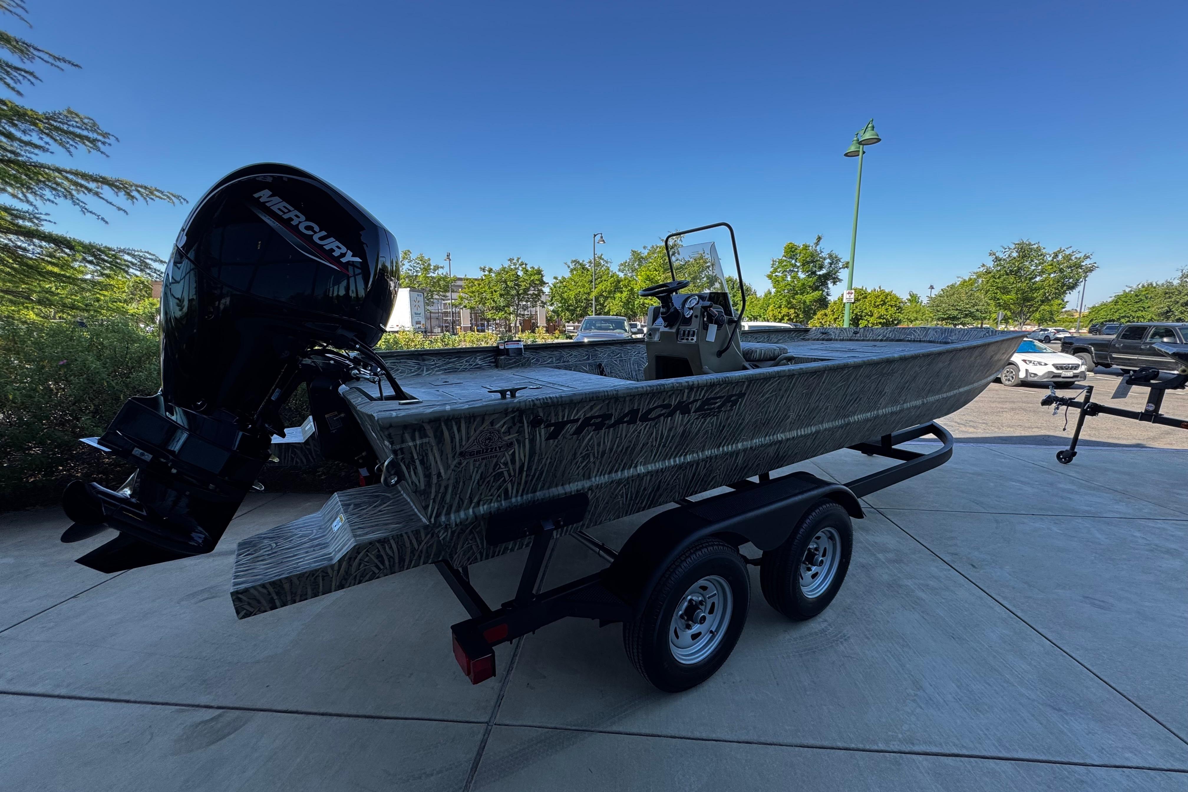 2026 Tracker Grizzly 2072 CC boat on trailer with Mercury outboard motor.