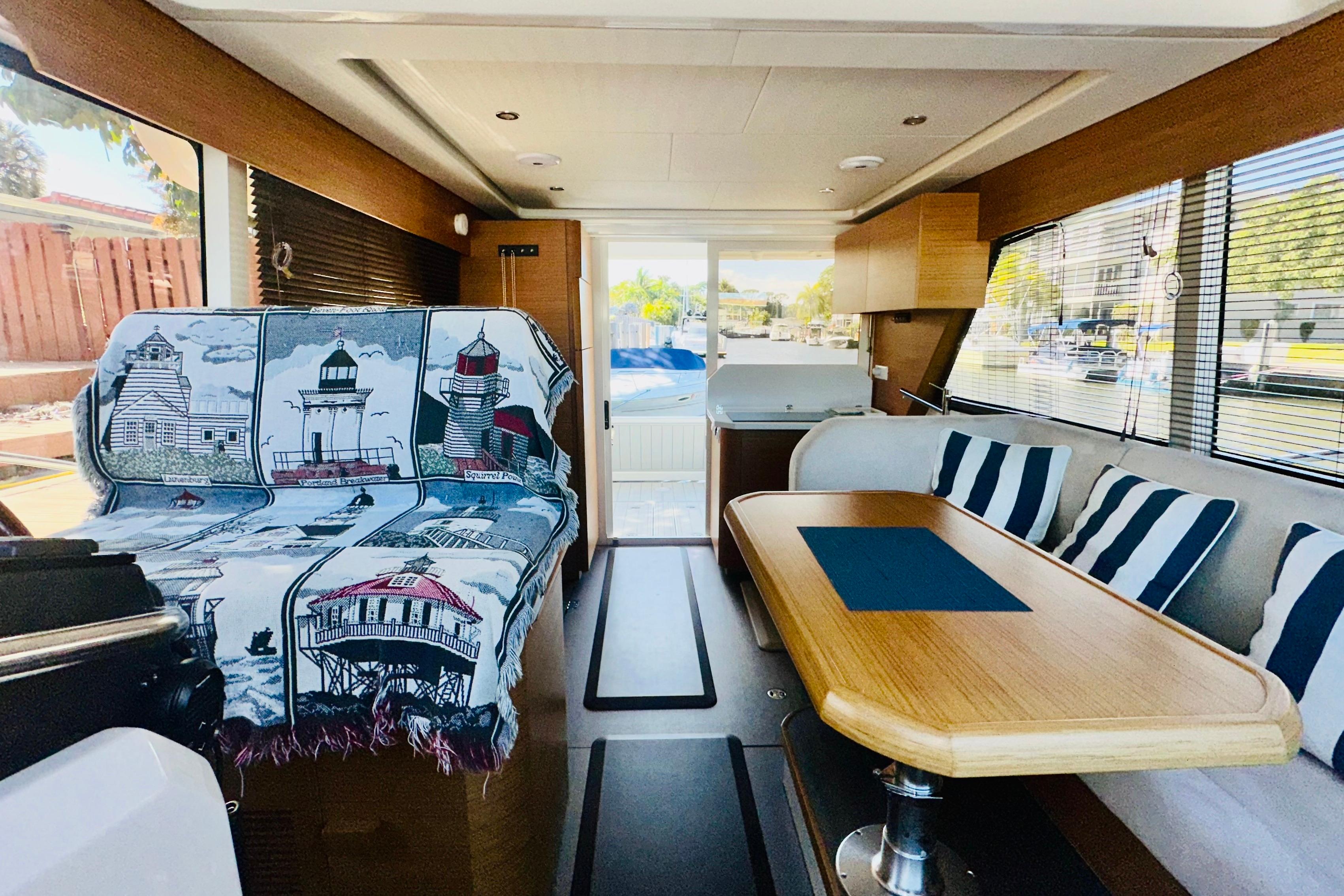 Interior of 2021 Greenline 39 Hybrid yacht with nautical decor and striped cushions.