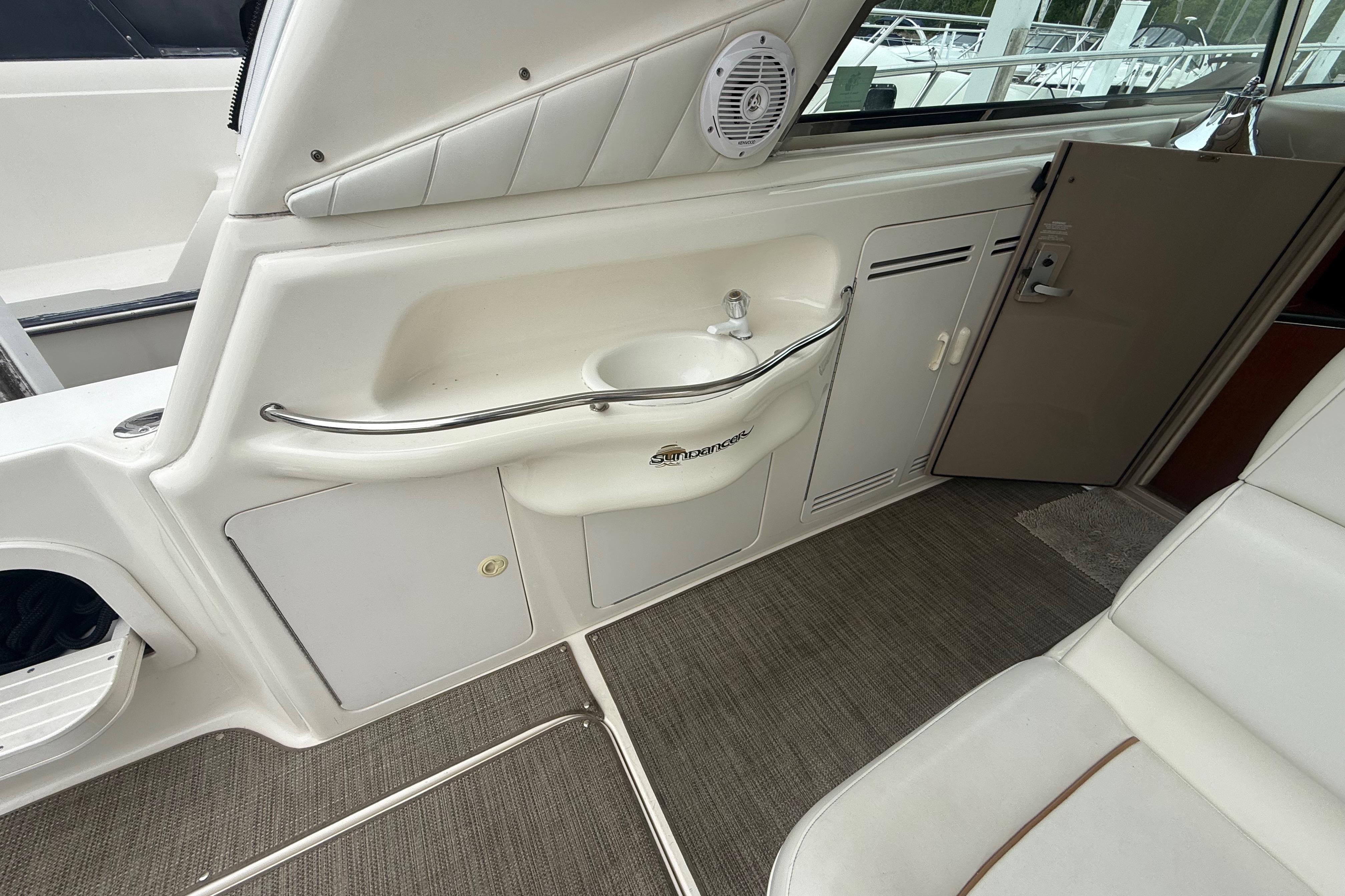 Interior of a 1998 Sea Ray Sundancer 400 yacht with sink and seating area.