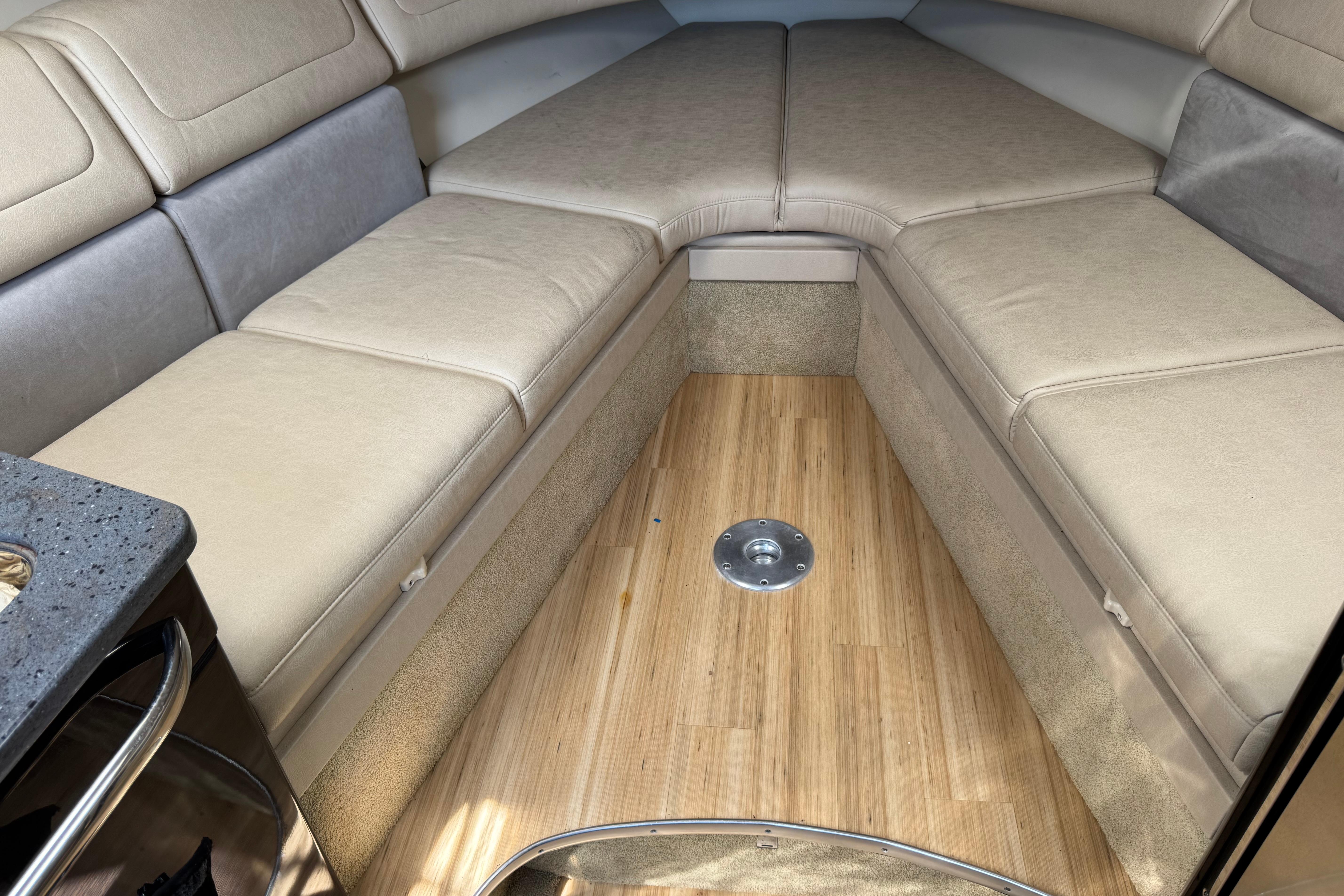 2014 Formula 350 Sun Sport cabin interior with beige seating and wooden flooring.