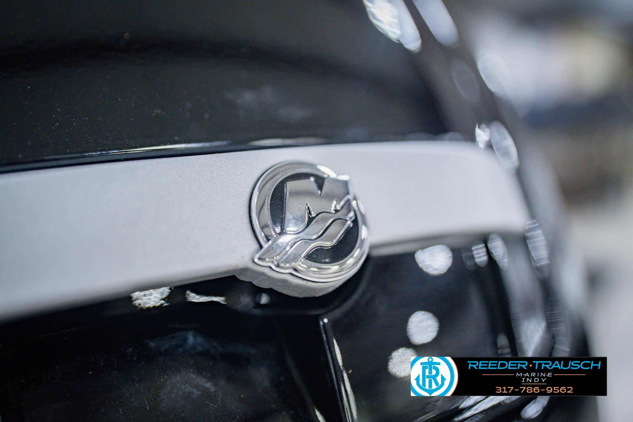 Close-up of 2026 Lund 1775 Impact XS logo on a sleek black surface.