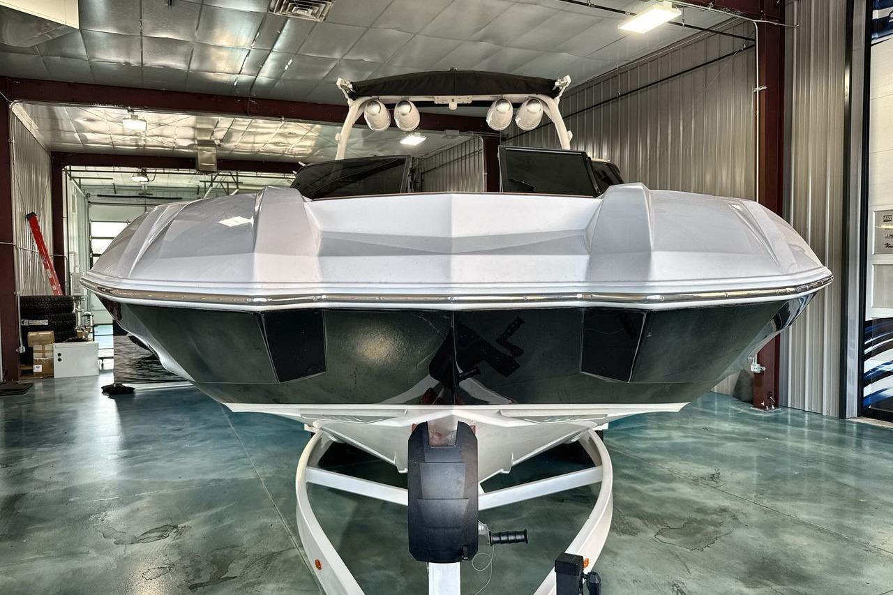 2020 Supra SE boat in a showroom, showcasing sleek design and modern features.