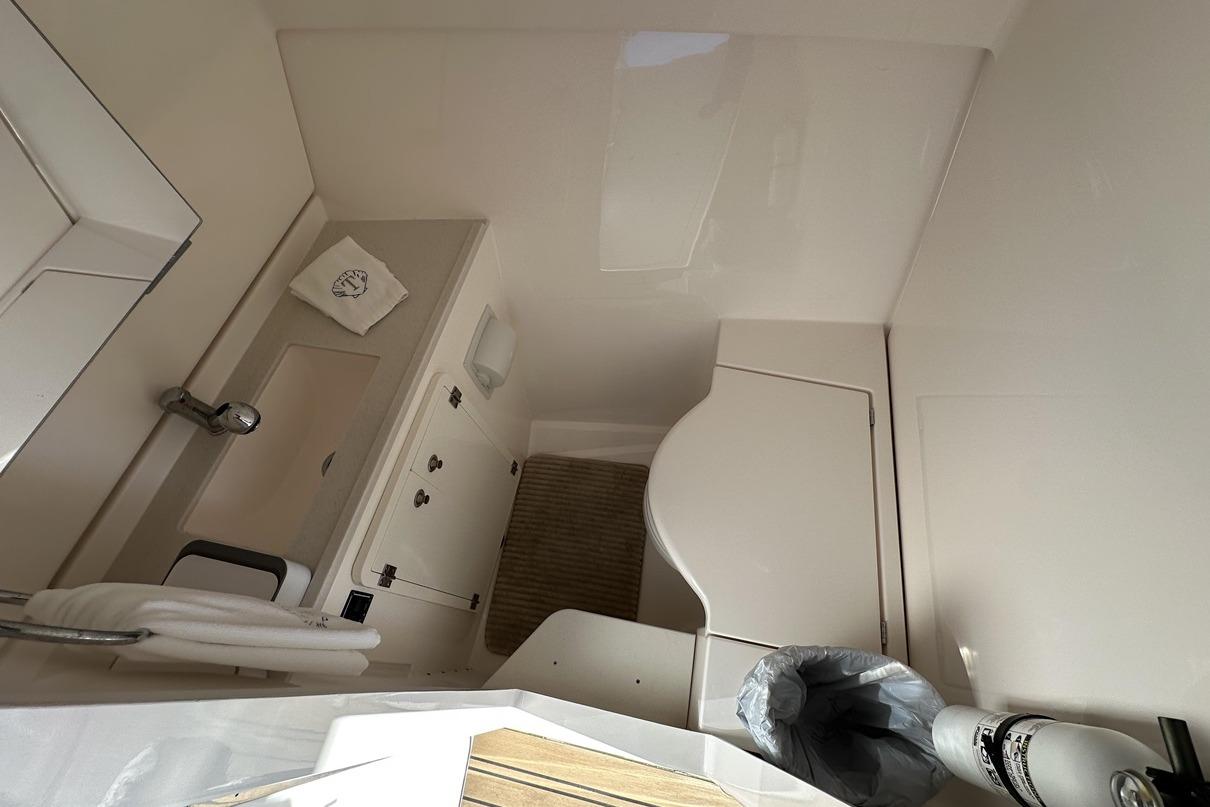 Interior of 2016 Pursuit DC 325 Dual Console boat bathroom with modern fixtures.