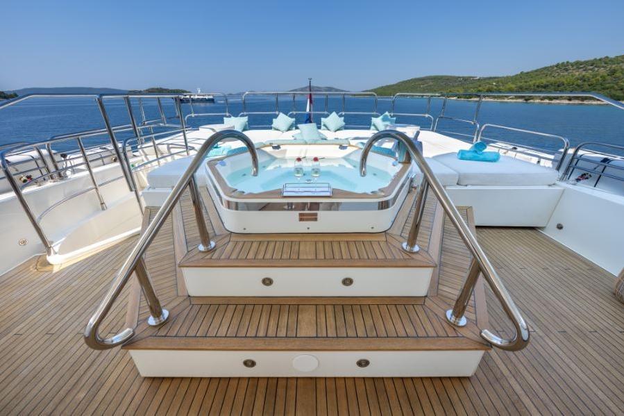 Luxurious Sunseeker 34 Metre Yacht 2009 with jacuzzi on deck, scenic ocean view.