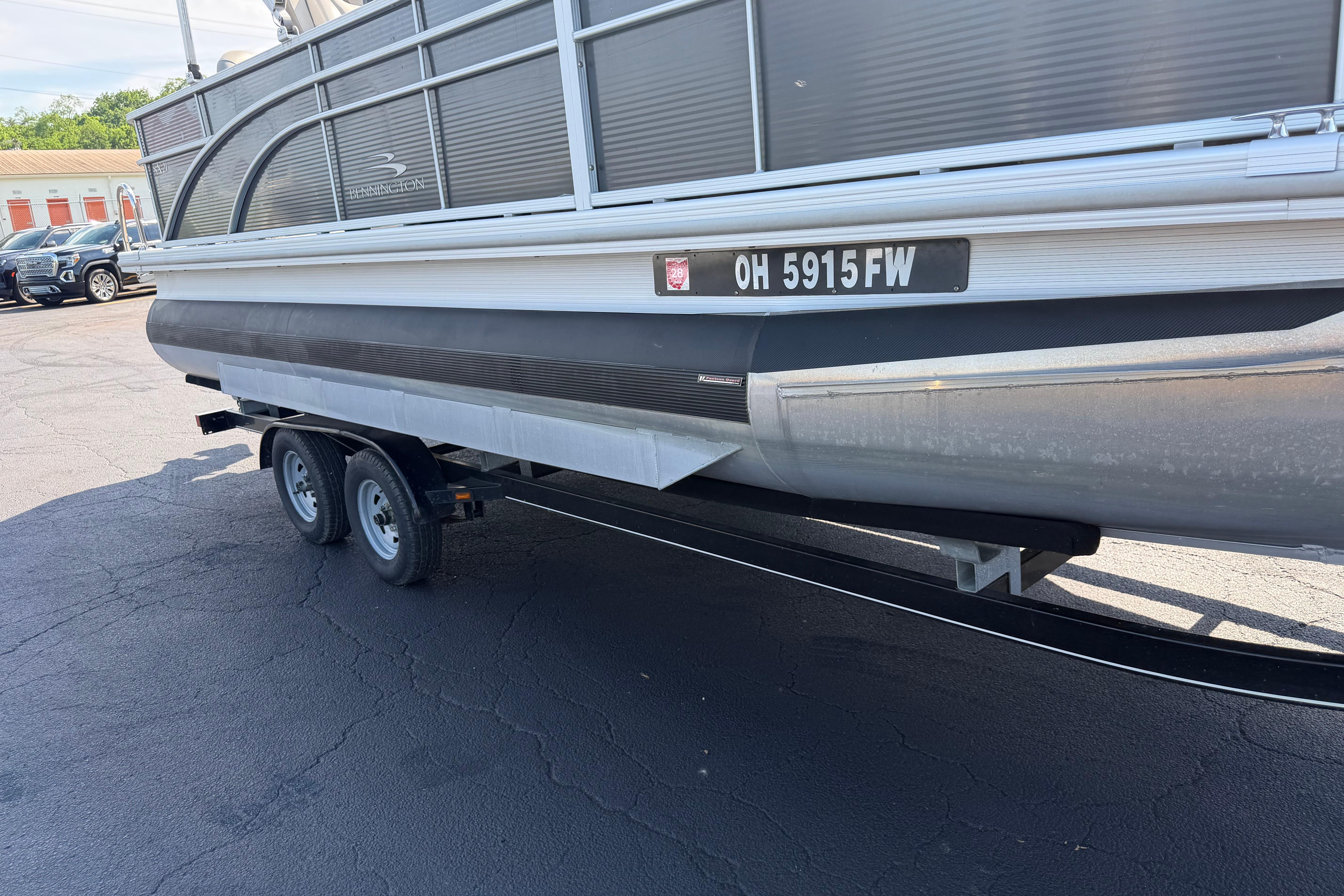 2018 Bennington 21 SF pontoon boat on trailer, parked in a lot.