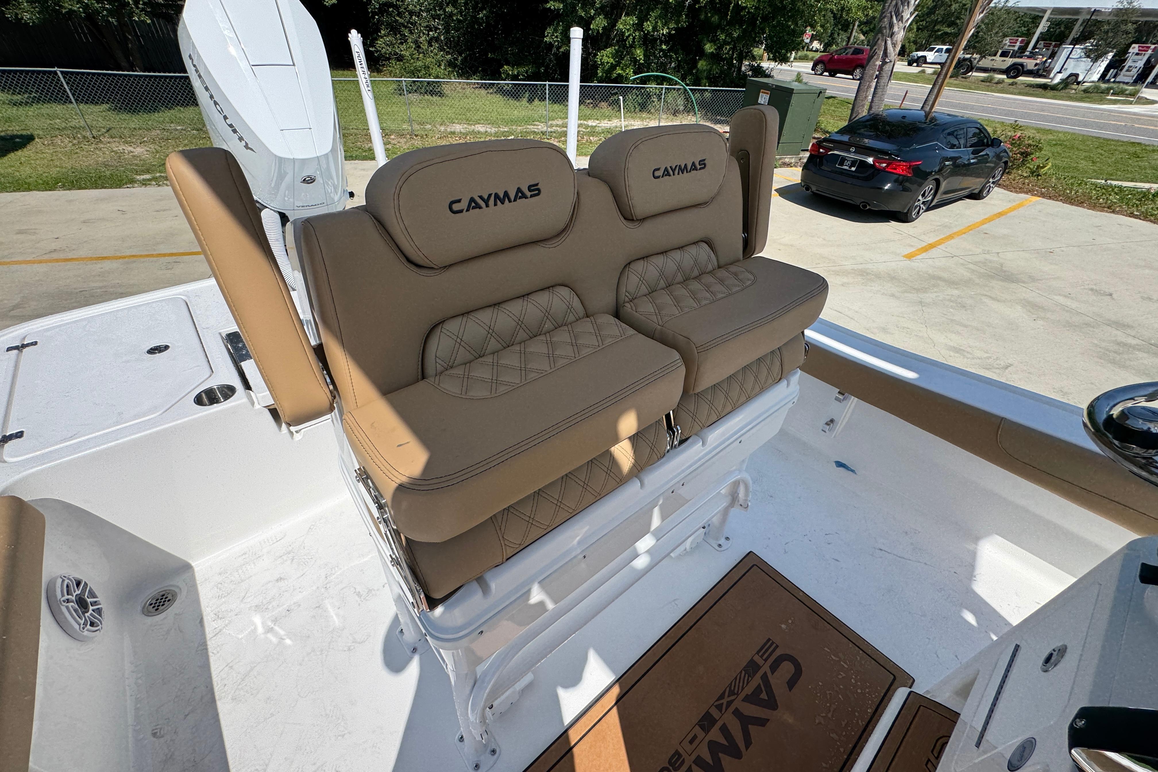 2027 Caymas 26 HB boat with tan cushioned seating and white deck.
