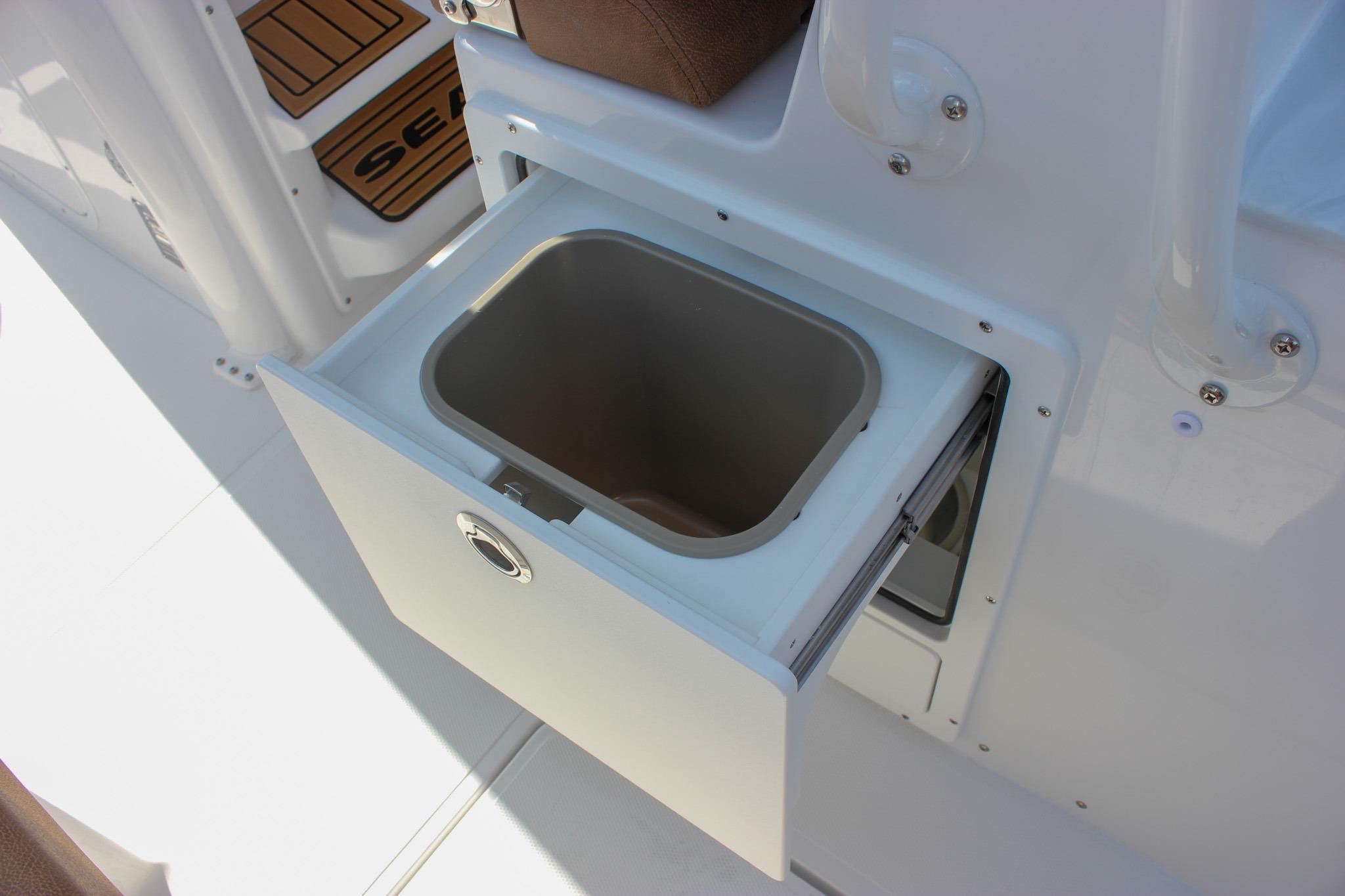 Open storage compartment on 2027 Sea Hunt Ultra 275 SE boat.