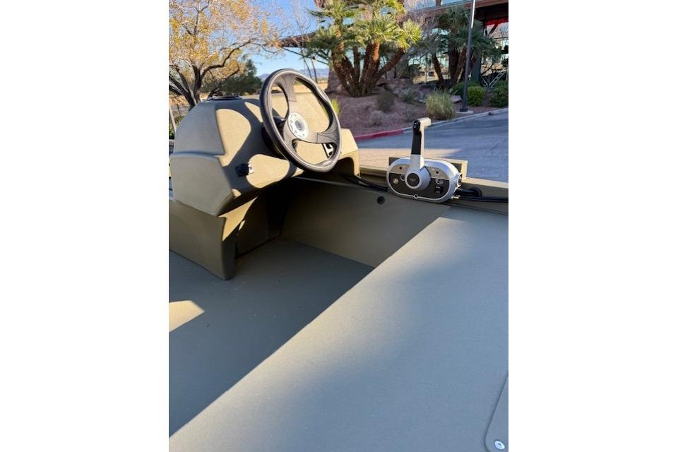2026 Tracker Grizzly 1648 SC boat interior with steering wheel and control panel.