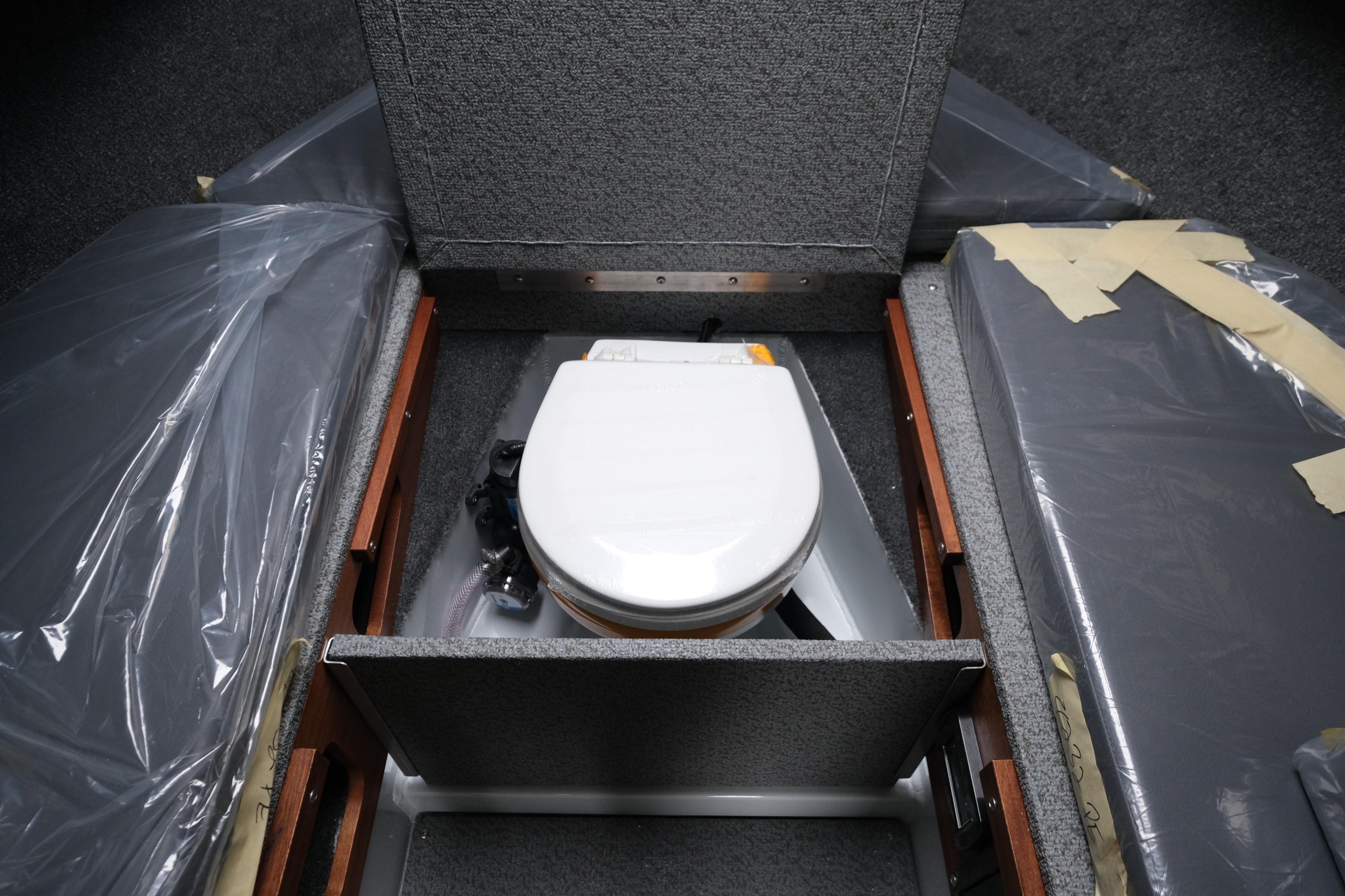2026 Hewescraft 270 Pacific Explorer interior with compact marine toilet.