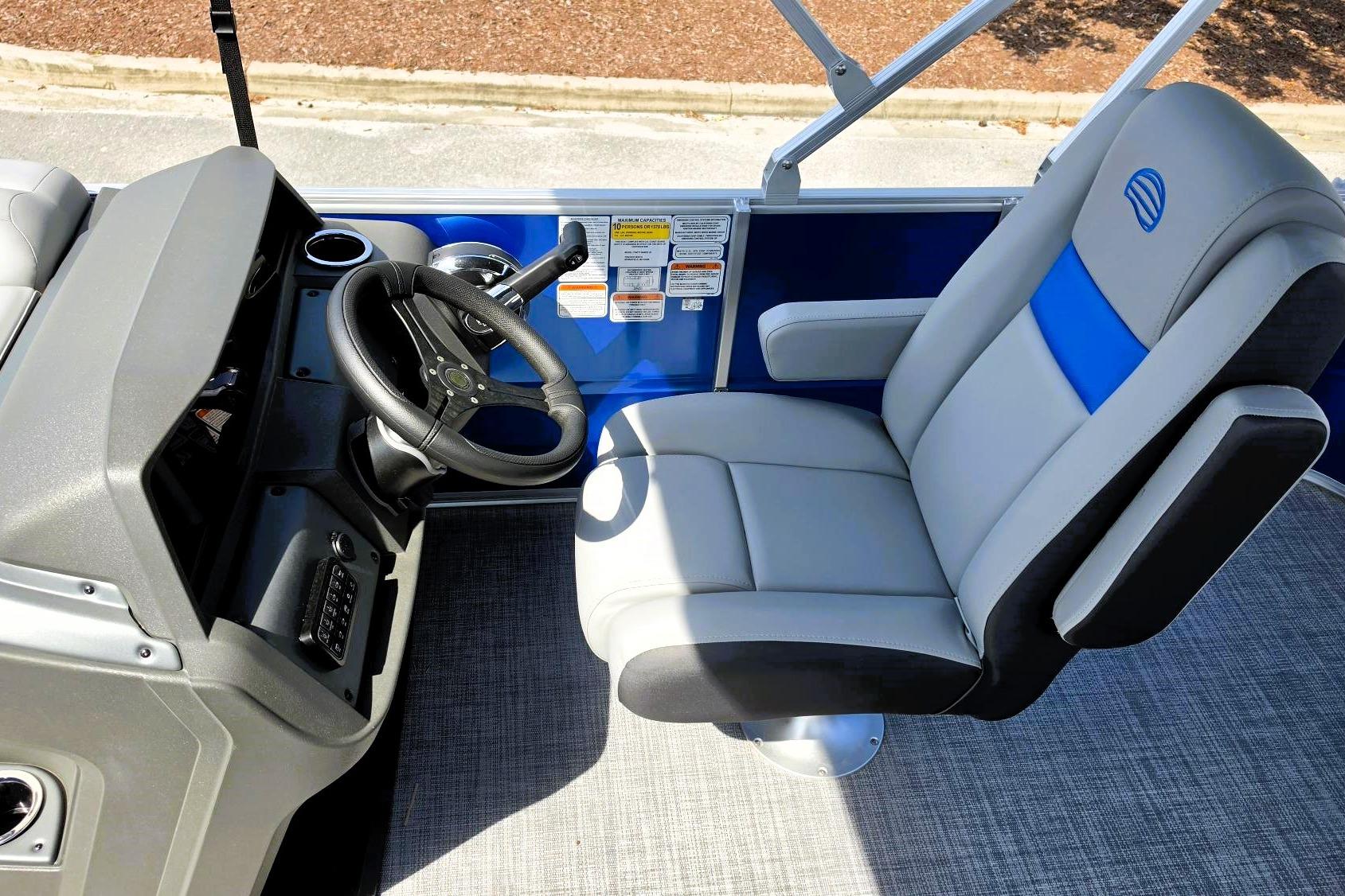 2026 Sun Tracker Party Barge 20 DLX helm with steering wheel and captain's chair.