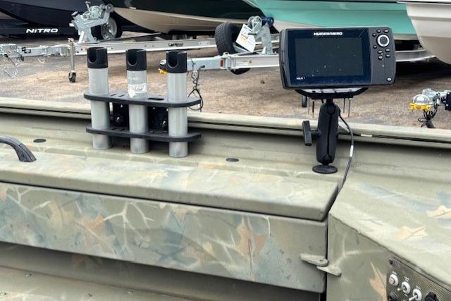 2017 Tracker Grizzly 1654 MVX Sportsman boat with mounted fish finder and rod holders.