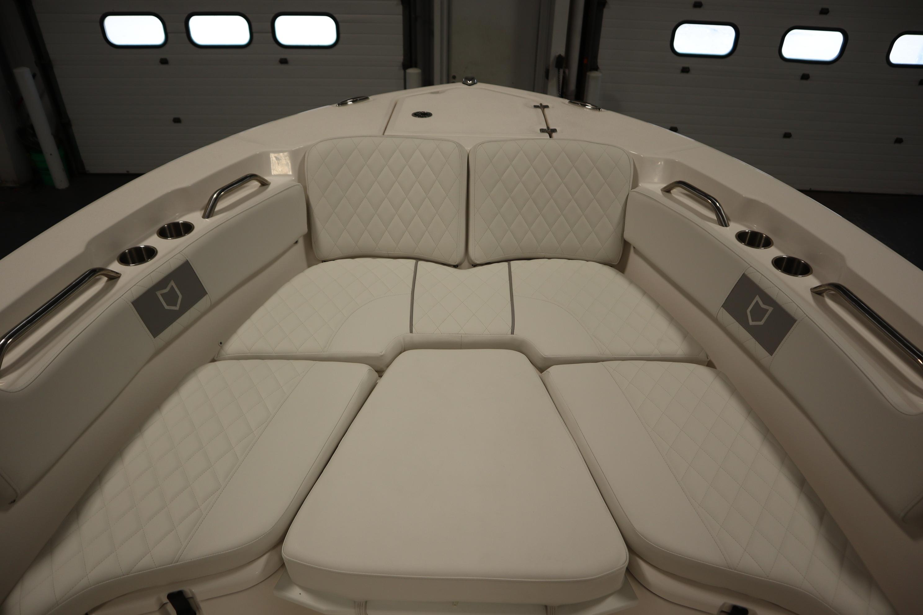 Luxurious seating area on 2026 Sea Fox 228 Commander boat, featuring quilted upholstery and cup holders.