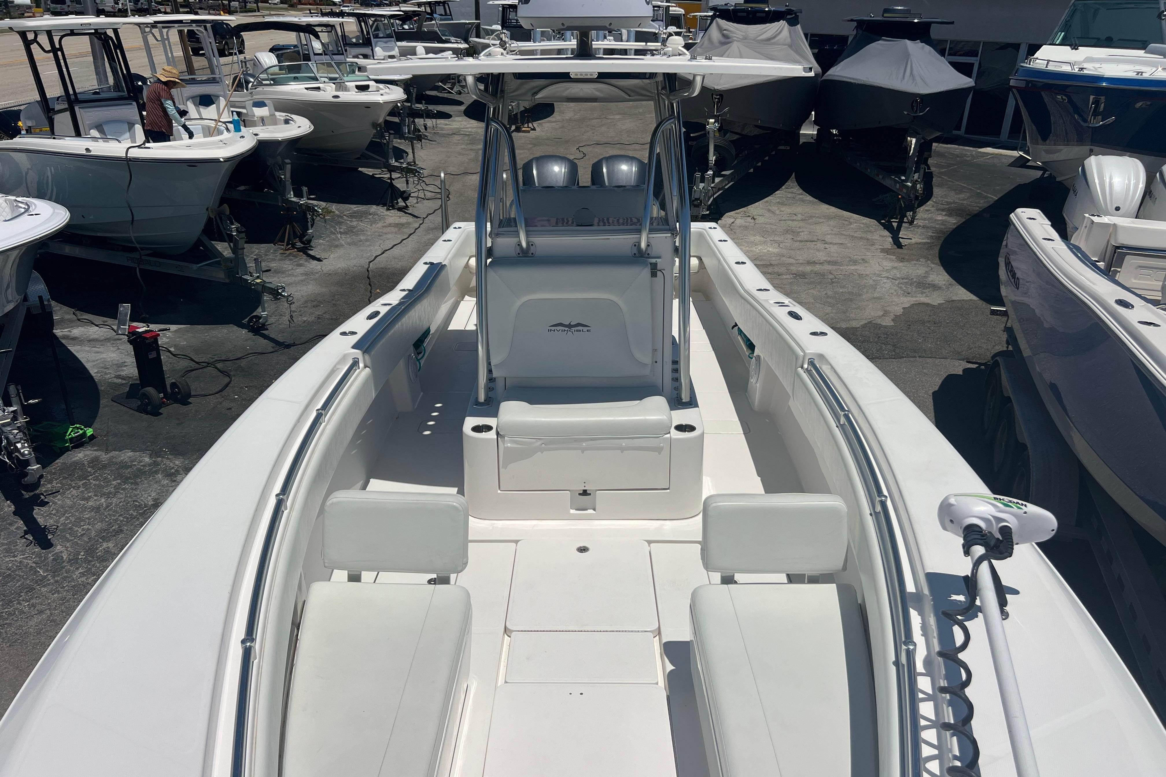 2012 Invincible 33 Open Fisherman boat in a marina, surrounded by other vessels.