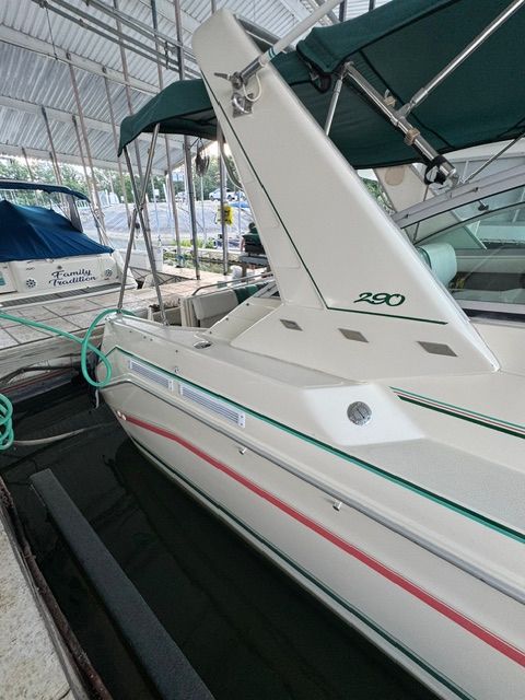 A 1992 Sea Ray 290 Sundancer is docked under a covered area.