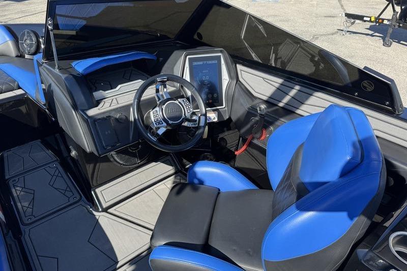 2022 Tigé Z3 boat interior with blue and black seating, modern dashboard, and steering wheel.