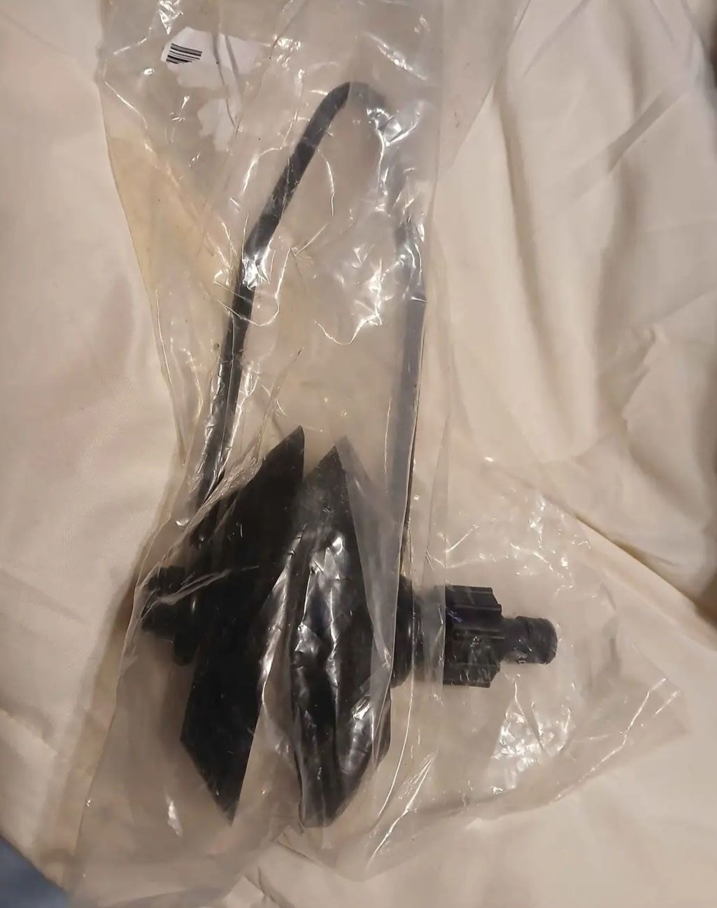 A packaged boat accessory, possibly a propeller, on a light background.