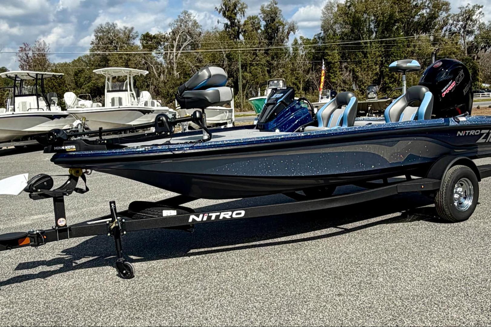 2026 Nitro Z18 boat on trailer, parked outdoors, with trees in the background.