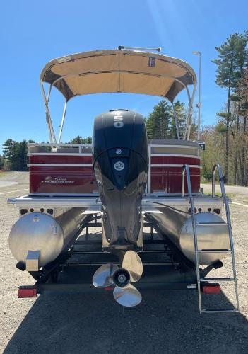 2025 Sun Tracker Party Barge 22 RF DLX pontoon boat with canopy and outboard motor.