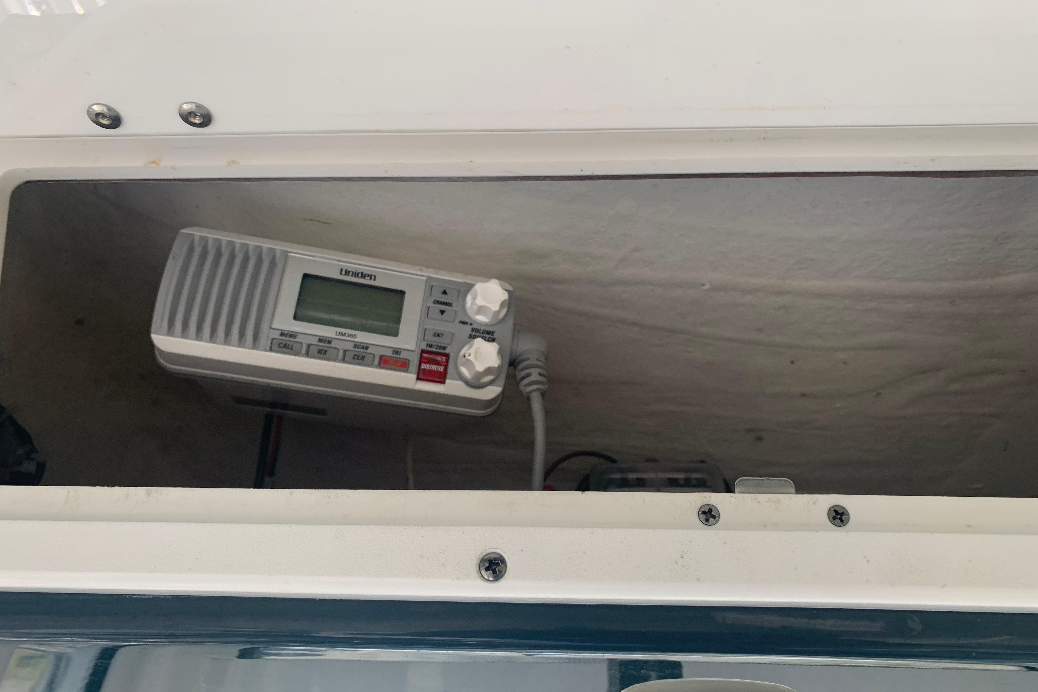 Radio equipment inside a 2021 Tidewater 256 CC Adventure boat compartment.