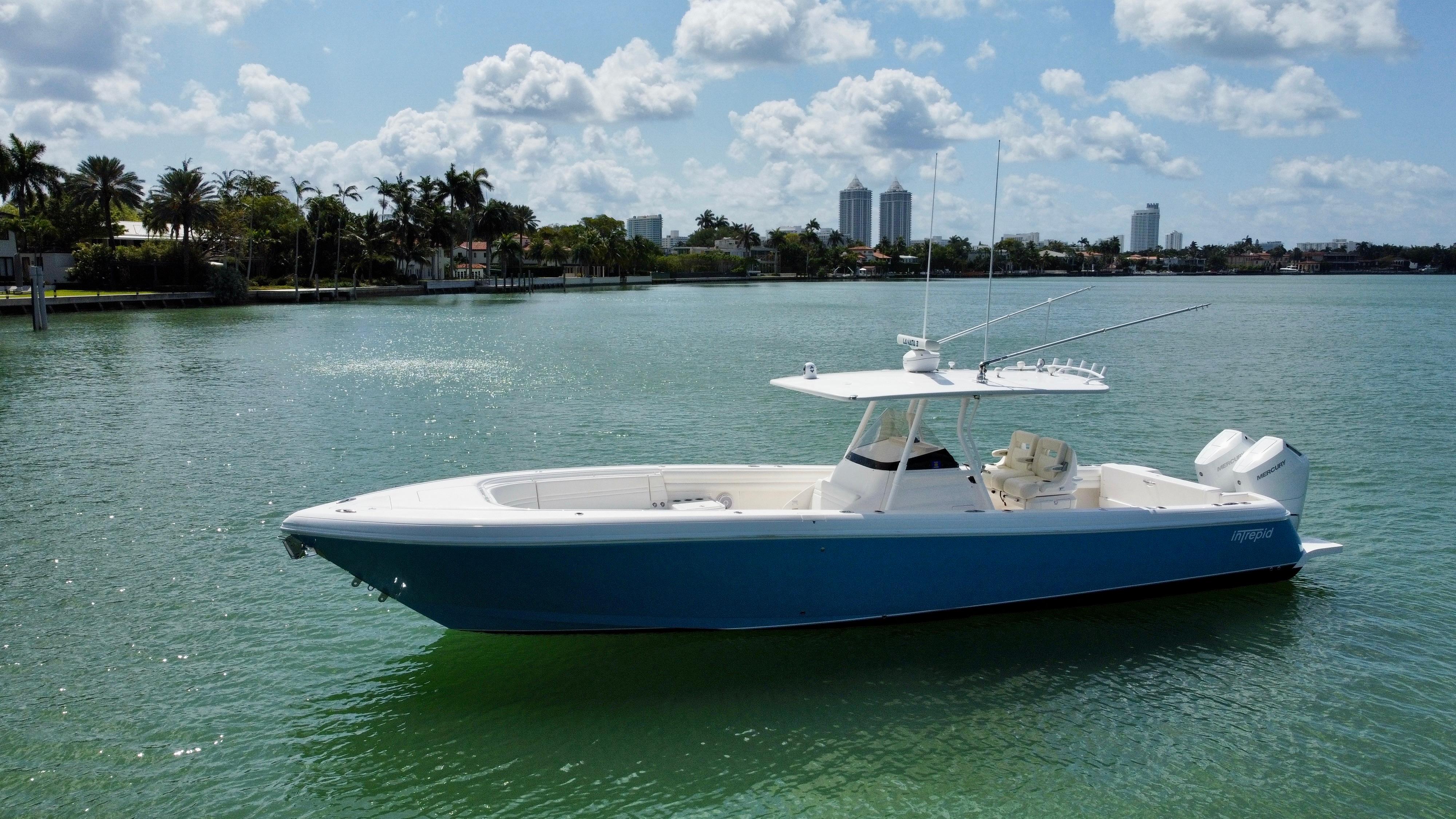 2015 Intrepid 375 Center Console boat on calm water under a partly cloudy sky.