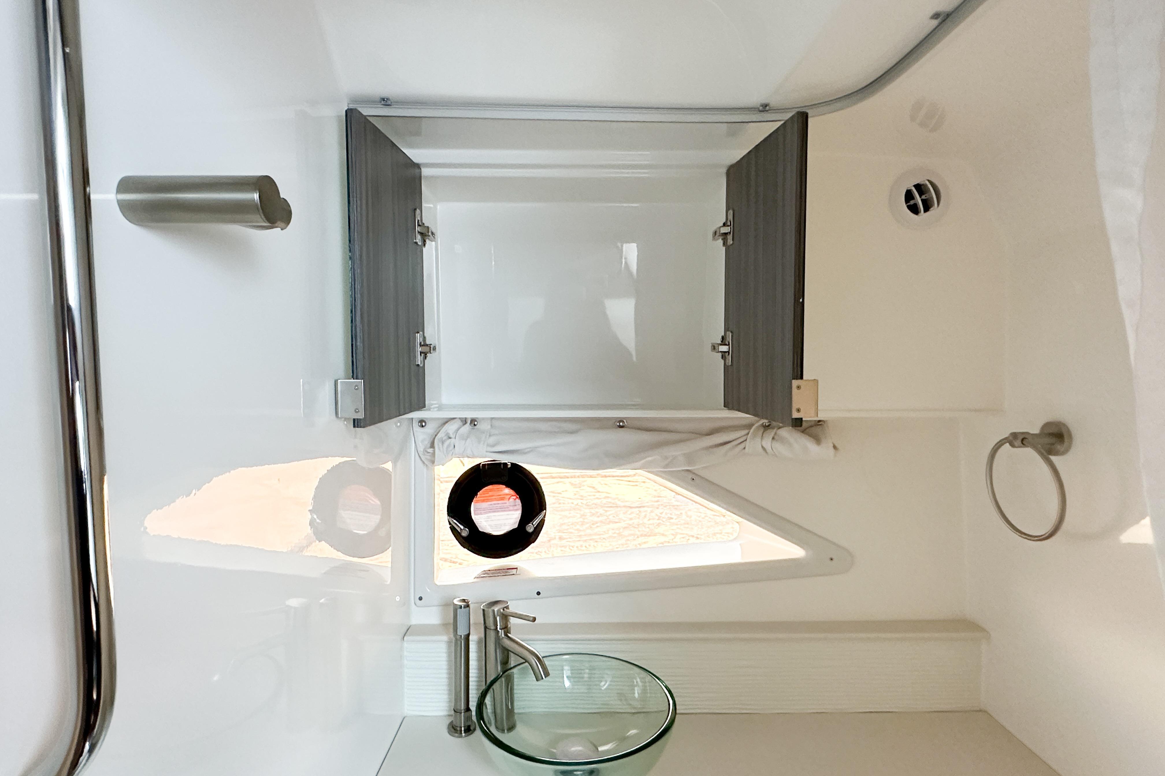 2026 Sea Ray Sundancer 320 bathroom with modern fixtures and open cabinet.