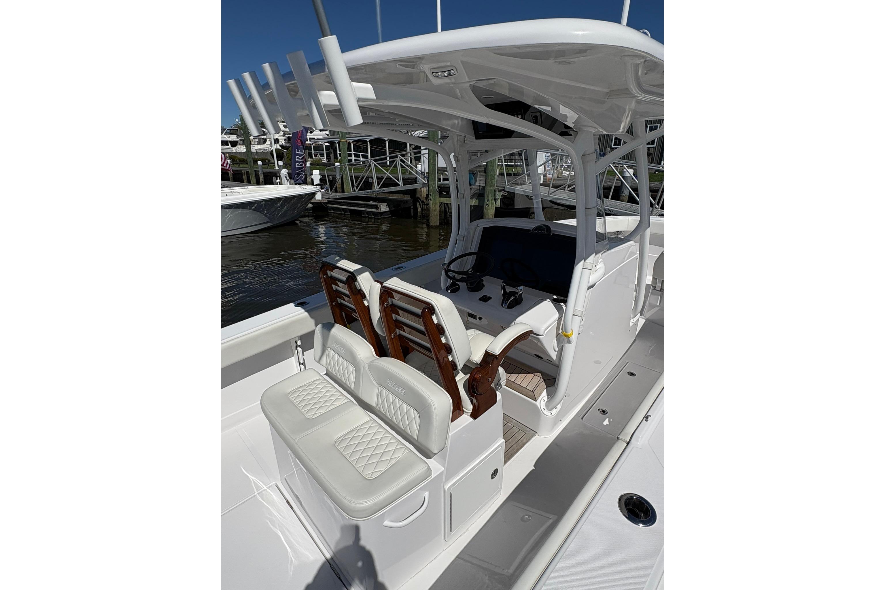 2023 Jupiter 30 boat interior with white seating and helm station.
