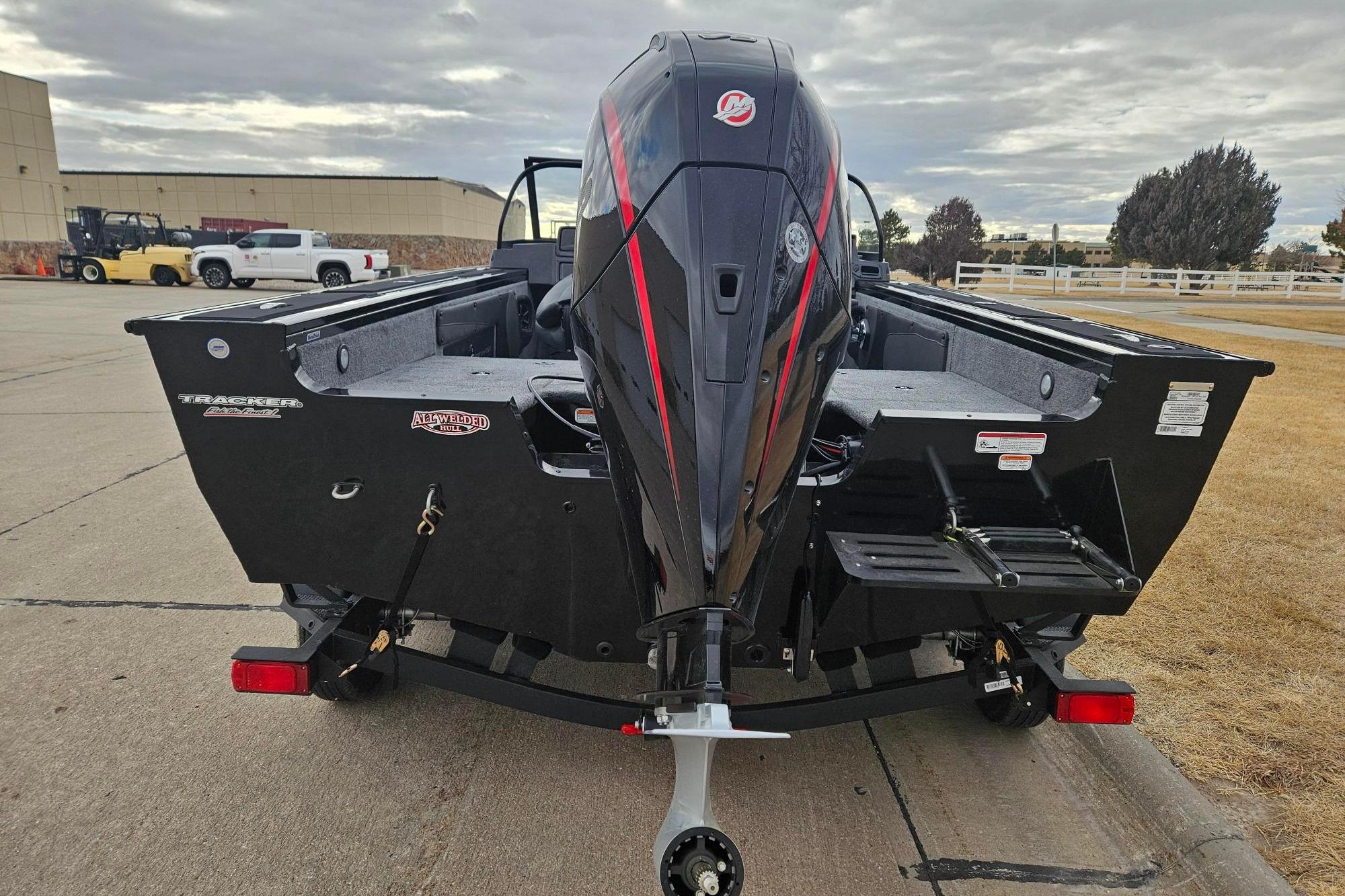 2026 Tracker Targa V-19 WT boat with powerful outboard motor, parked outdoors.