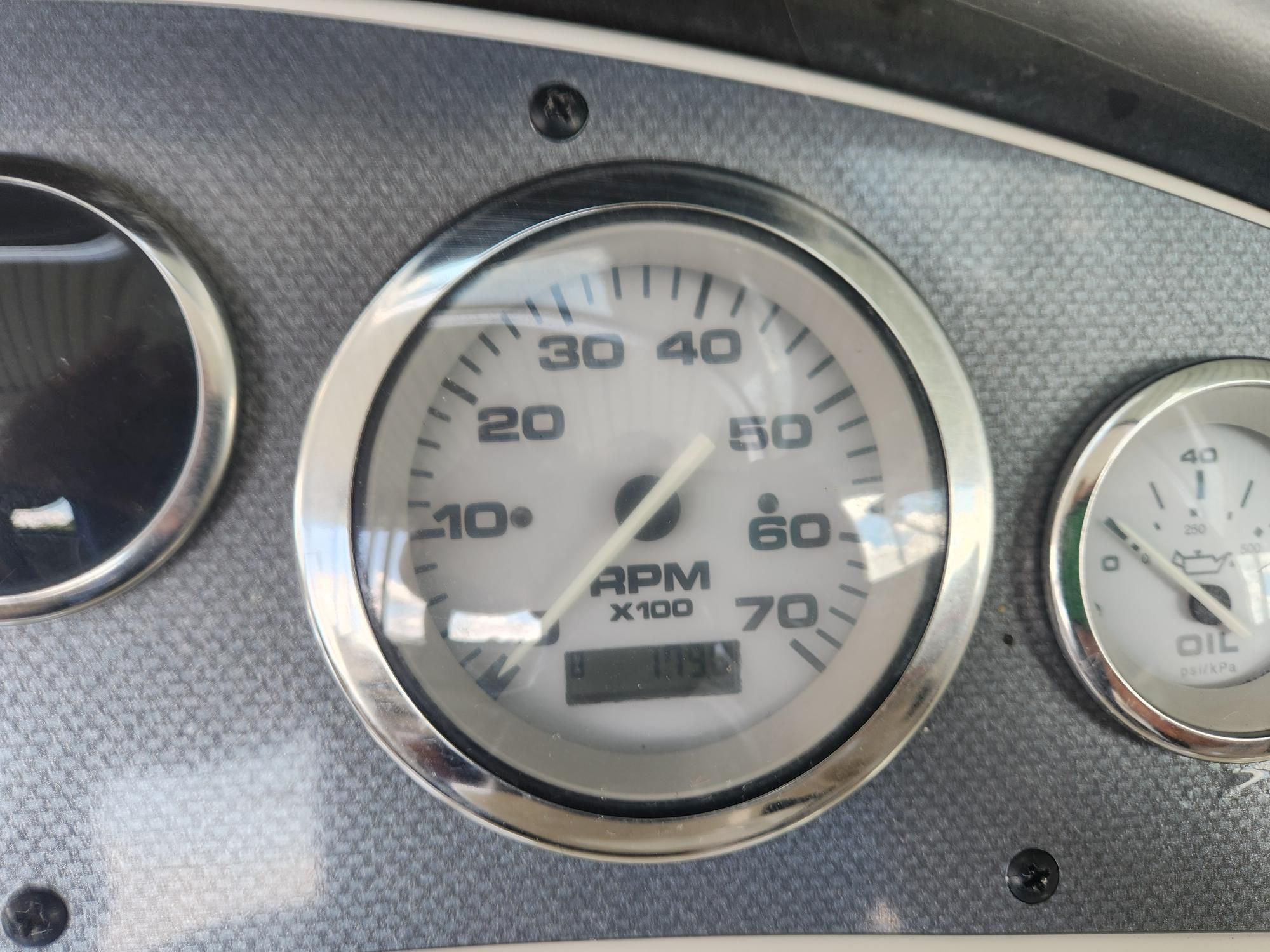 Tachometer and oil pressure gauge of a 2004 Sea Ray 185 boat.