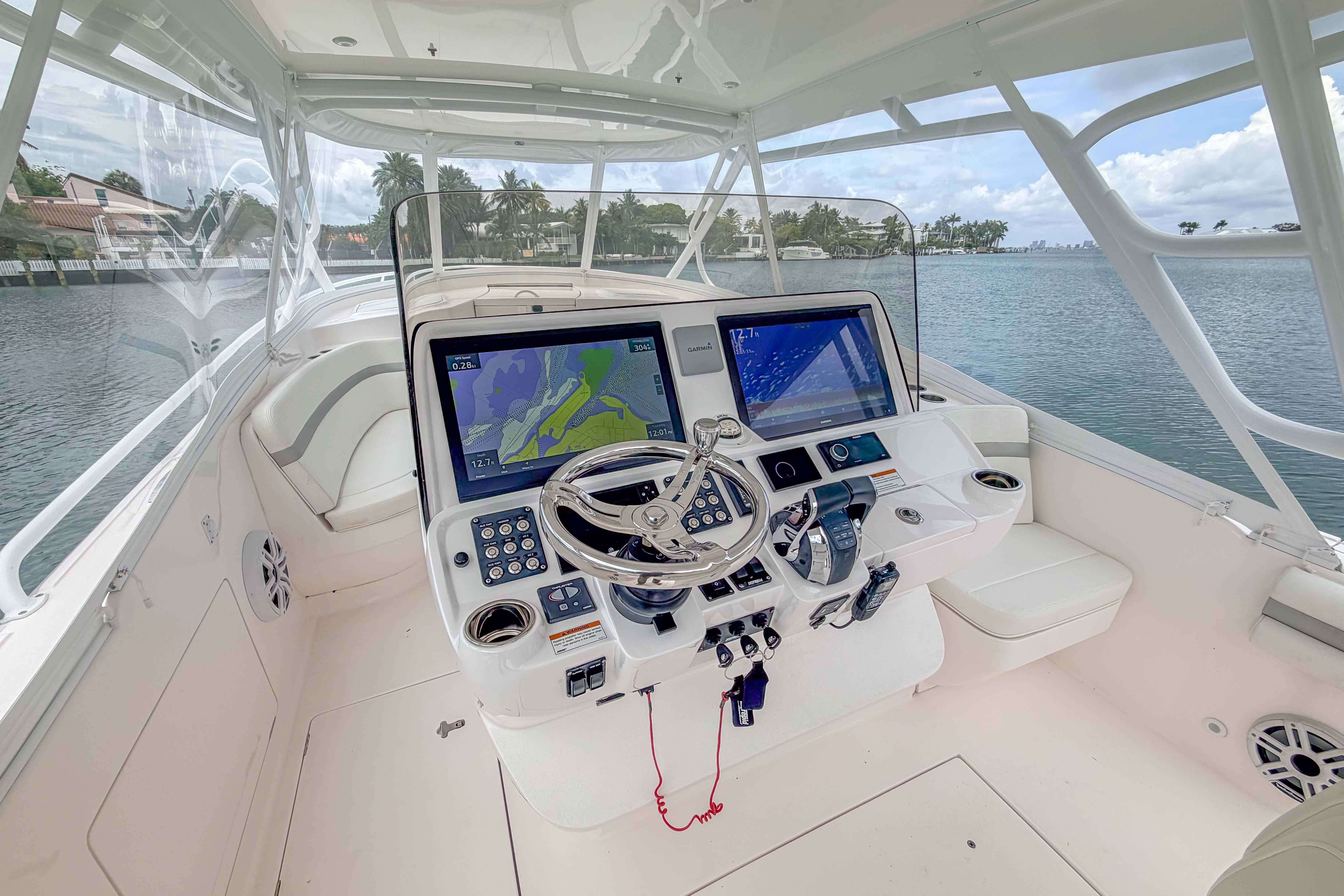 2021 Intrepid 409 Valor boat cockpit with advanced navigation system and steering wheel.
