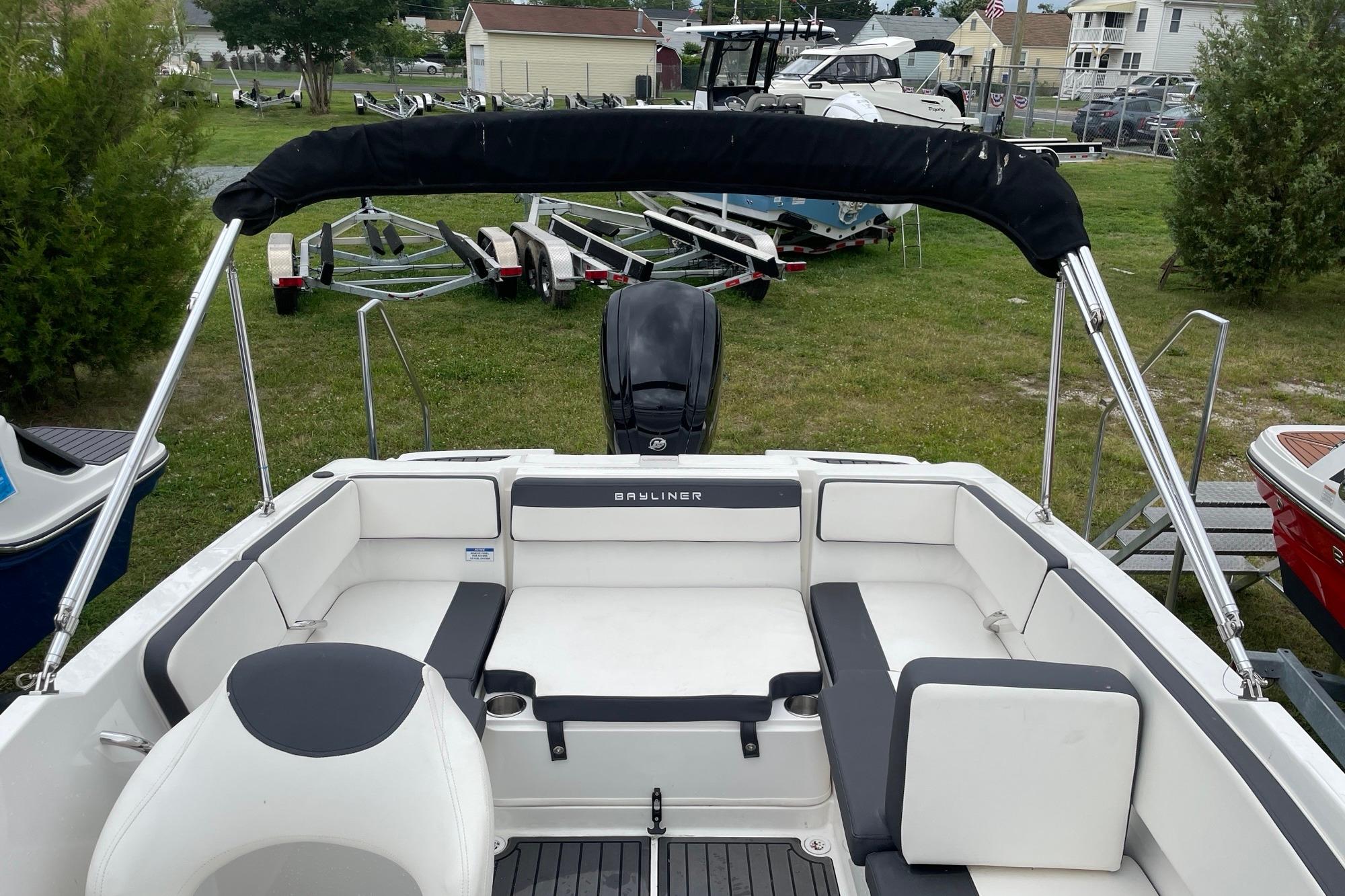 2023 Bayliner VR4 Bowrider OB with spacious seating and sleek design in a grassy area.