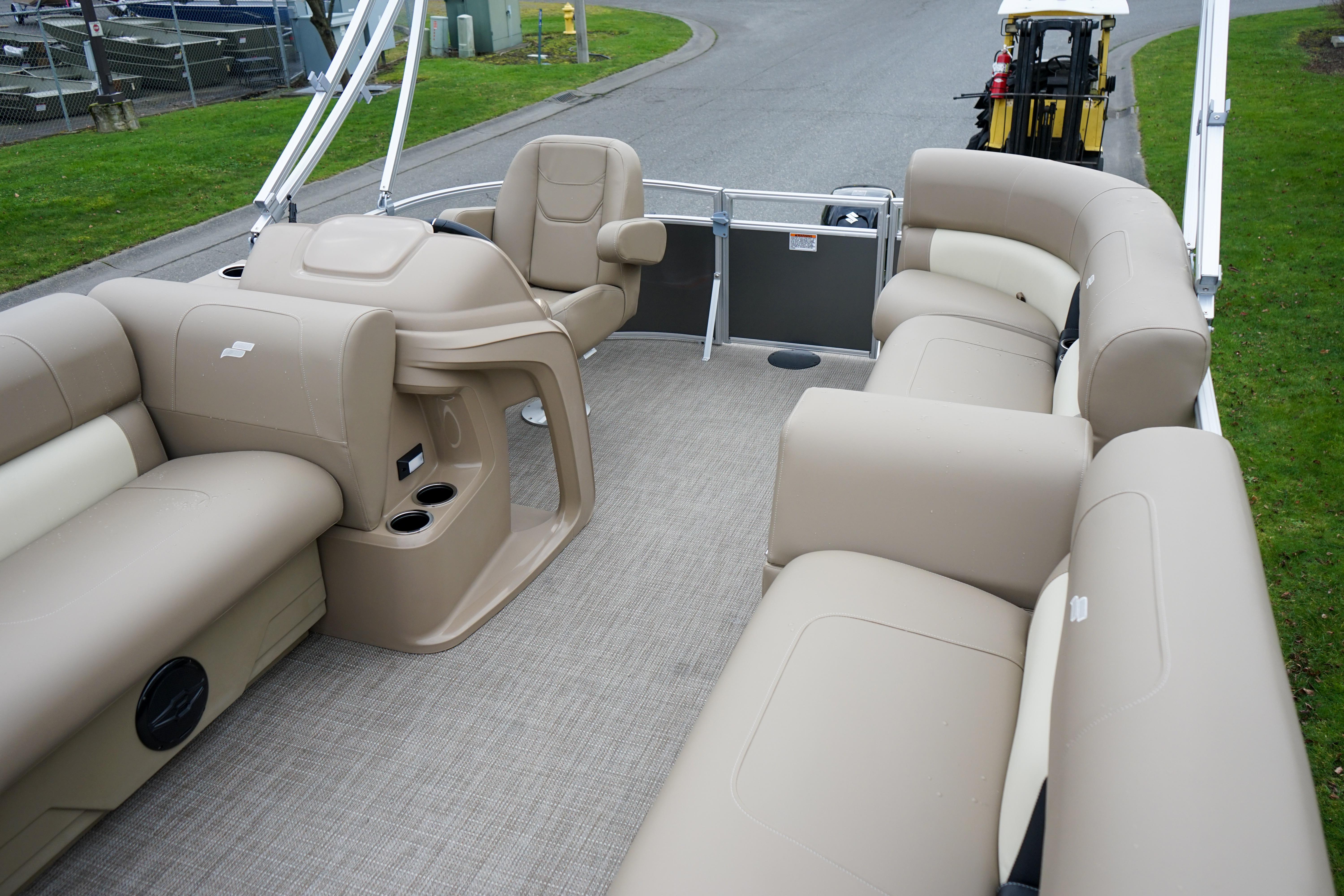 2025 Starcraft LX16R pontoon boat interior with beige seating and steering console.
