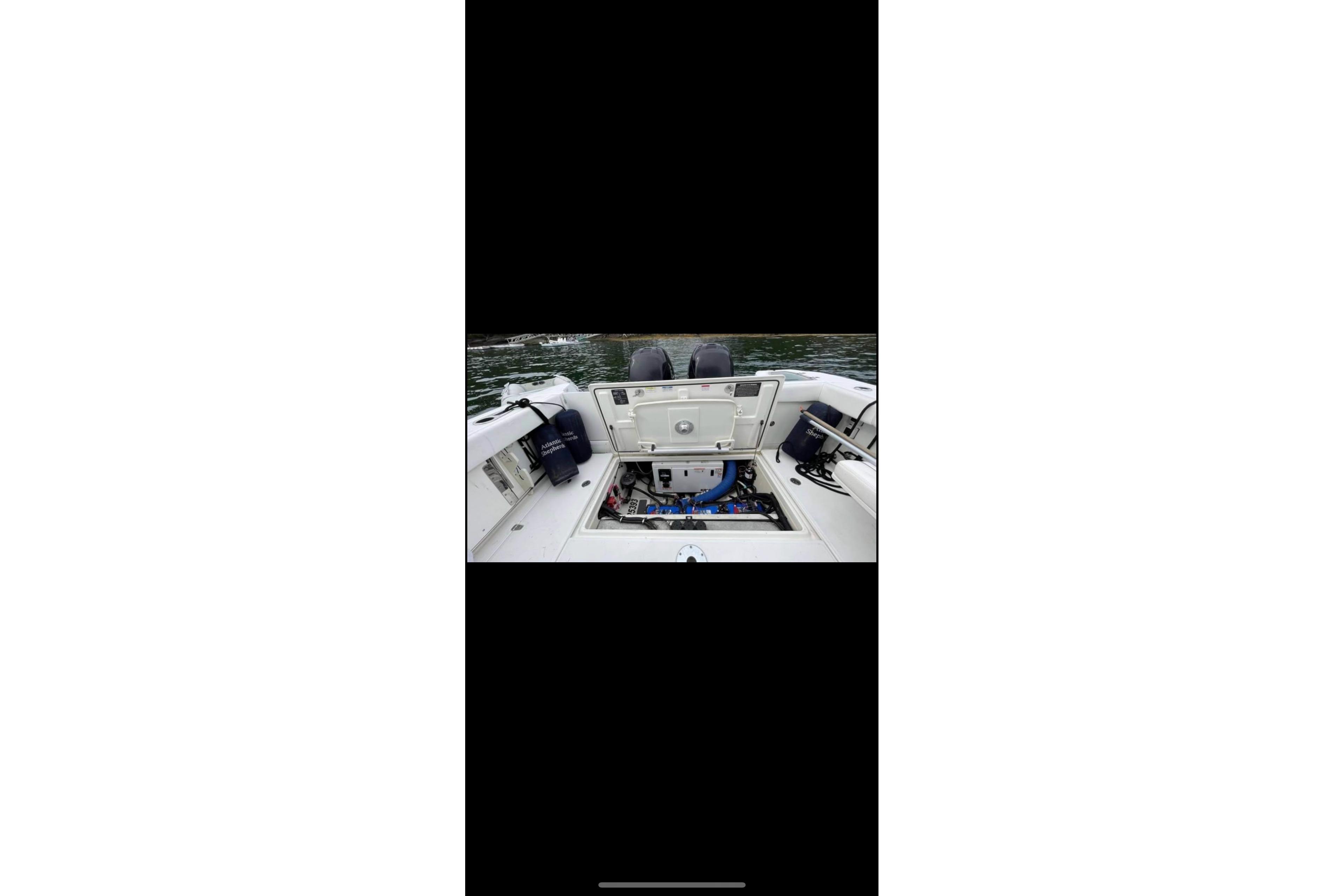 2013 Boston Whaler 315 Conquest boat interior with open hatch, showing equipment.