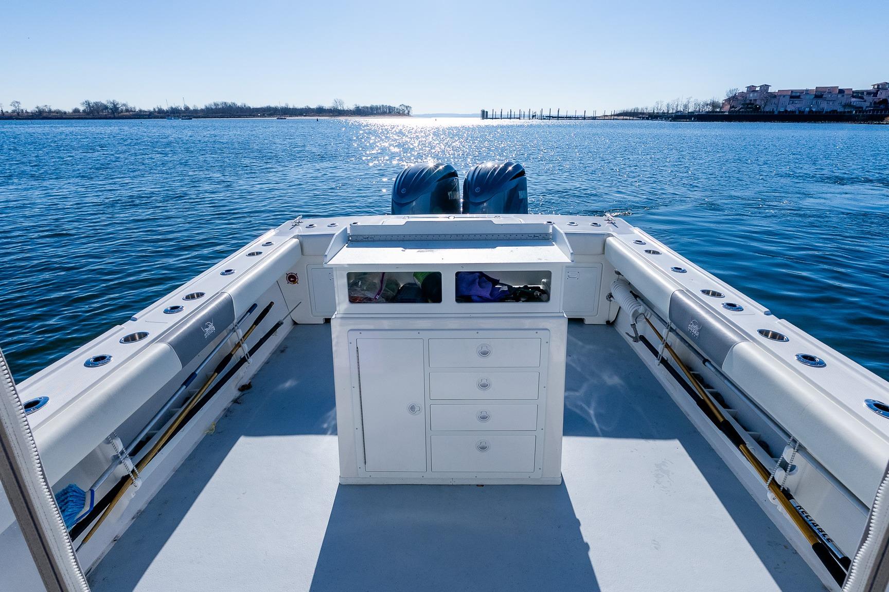 2024 Steiger Craft 31 Fisherman boat on calm water, featuring spacious deck and dual engines.