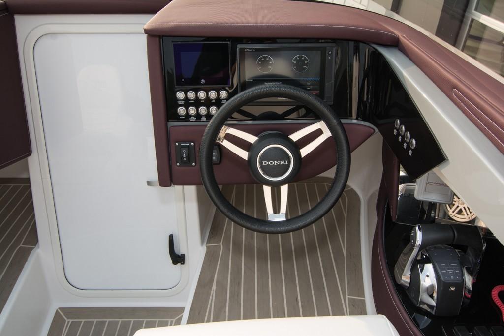 2019 Donzi 41 GT boat cockpit with steering wheel and control panel.