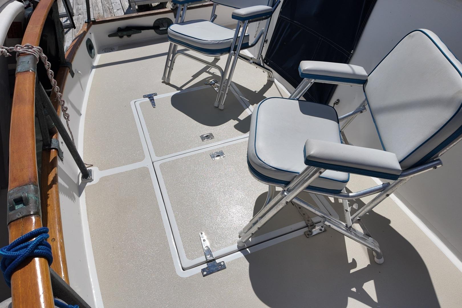 Deck seating on a 1978 Grand Banks 42 Classic yacht, featuring two cushioned chairs.