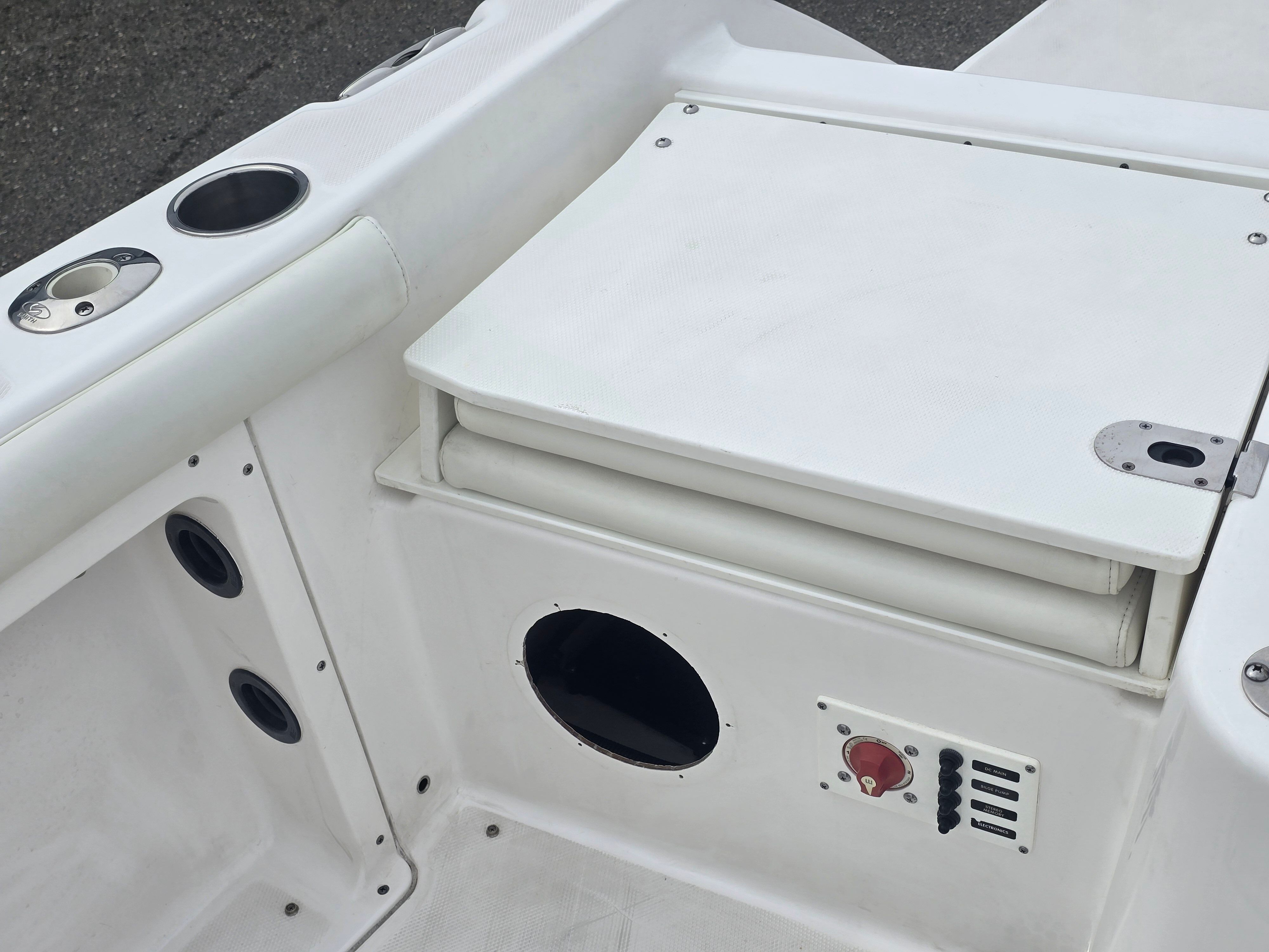Close-up of a white boat seat with cup holders and speakers.